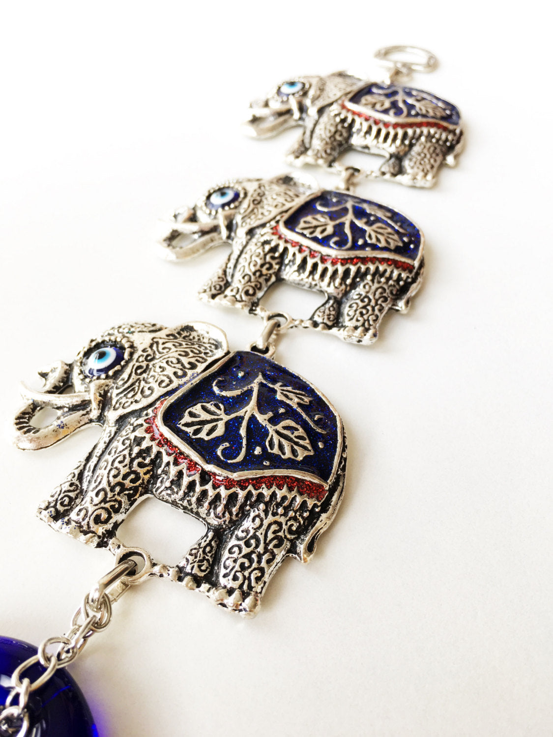 Handmade Lucky Elephant Evil Eye Wall Decor featuring a metal elephant and glass evil eye, symbolizing protection and good luck.