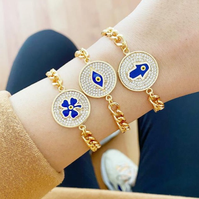 Lucky Evil Eye Bracelet featuring gold link chain and protective charms like Hamsa Hand and Clover, adorned with blue beads.