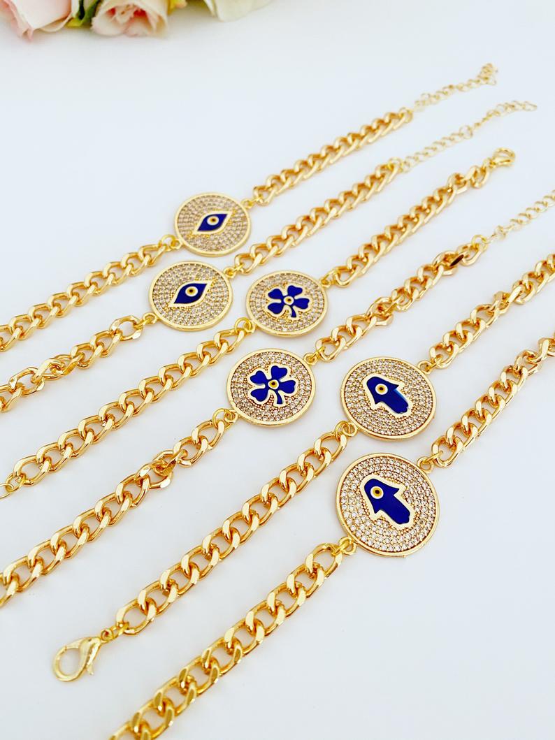 Lucky Evil Eye Bracelet featuring gold link chain and protective charms like Hamsa Hand and Clover, adorned with blue beads.