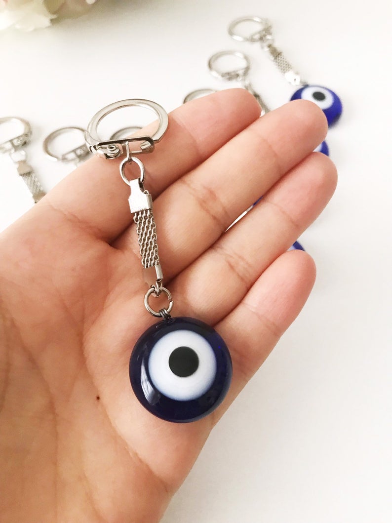 Lucky Evil Eye Greek Keychain featuring a glass evil eye bead and various charm styles.