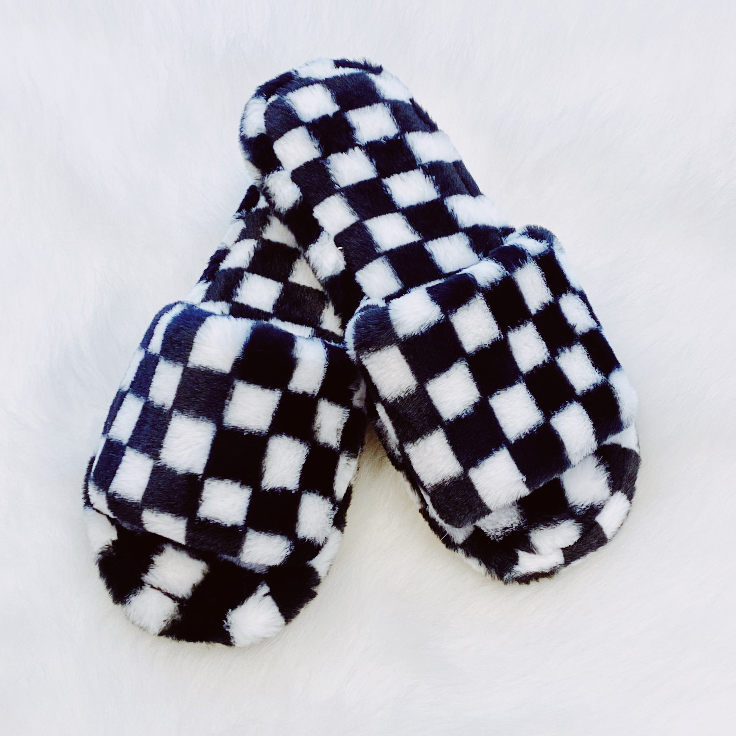 Luxe Lounge Checker Cozy Slippers featuring a stylish checker pattern and open toe design, perfect for comfort and relaxation.