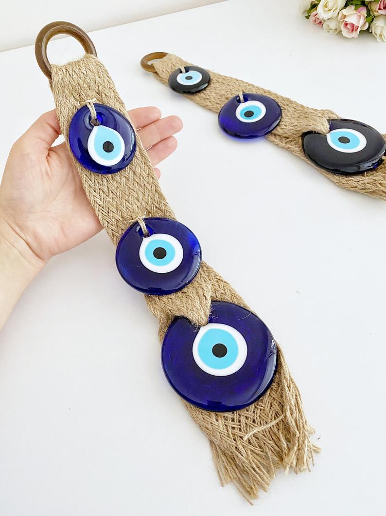 A beautifully crafted macrame wall hanging featuring blue evil eye beads, symbolizing protection and elegance in home decor.