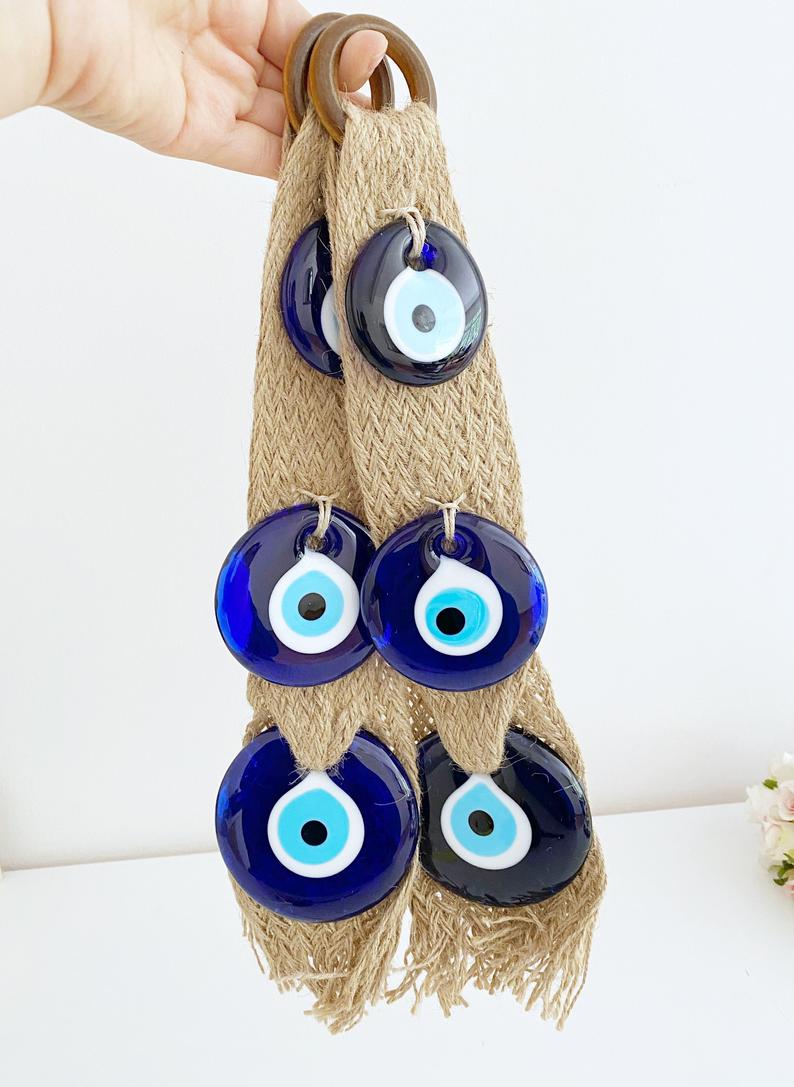 A beautifully crafted macrame wall hanging featuring blue evil eye beads, symbolizing protection and elegance in home decor.
