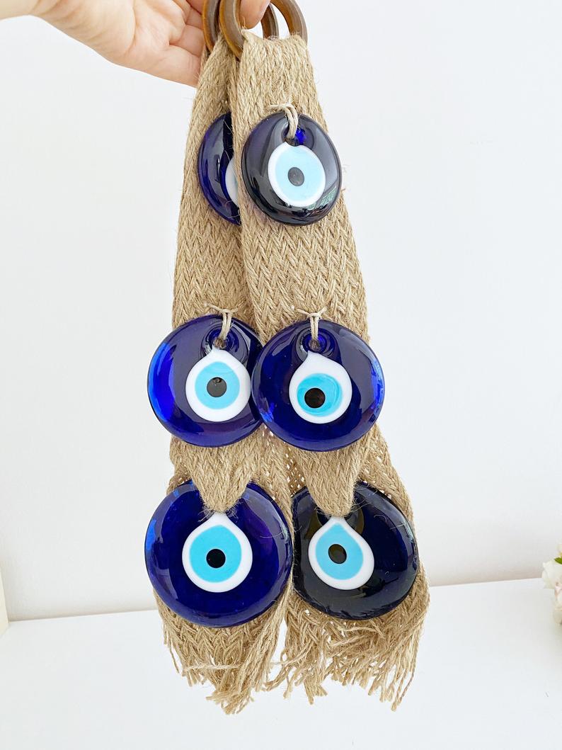 A beautifully crafted macrame wall hanging featuring blue evil eye beads, symbolizing protection and elegance in home decor.