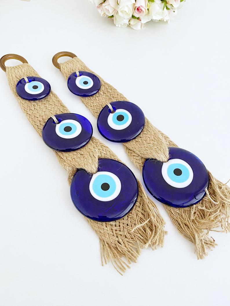 A beautifully crafted macrame wall hanging featuring blue evil eye beads, symbolizing protection and elegance in home decor.