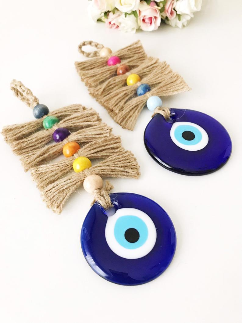 A beautifully crafted macrame evil eye wall hanging featuring colorful beads and intricate knots, symbolizing protection and good luck.