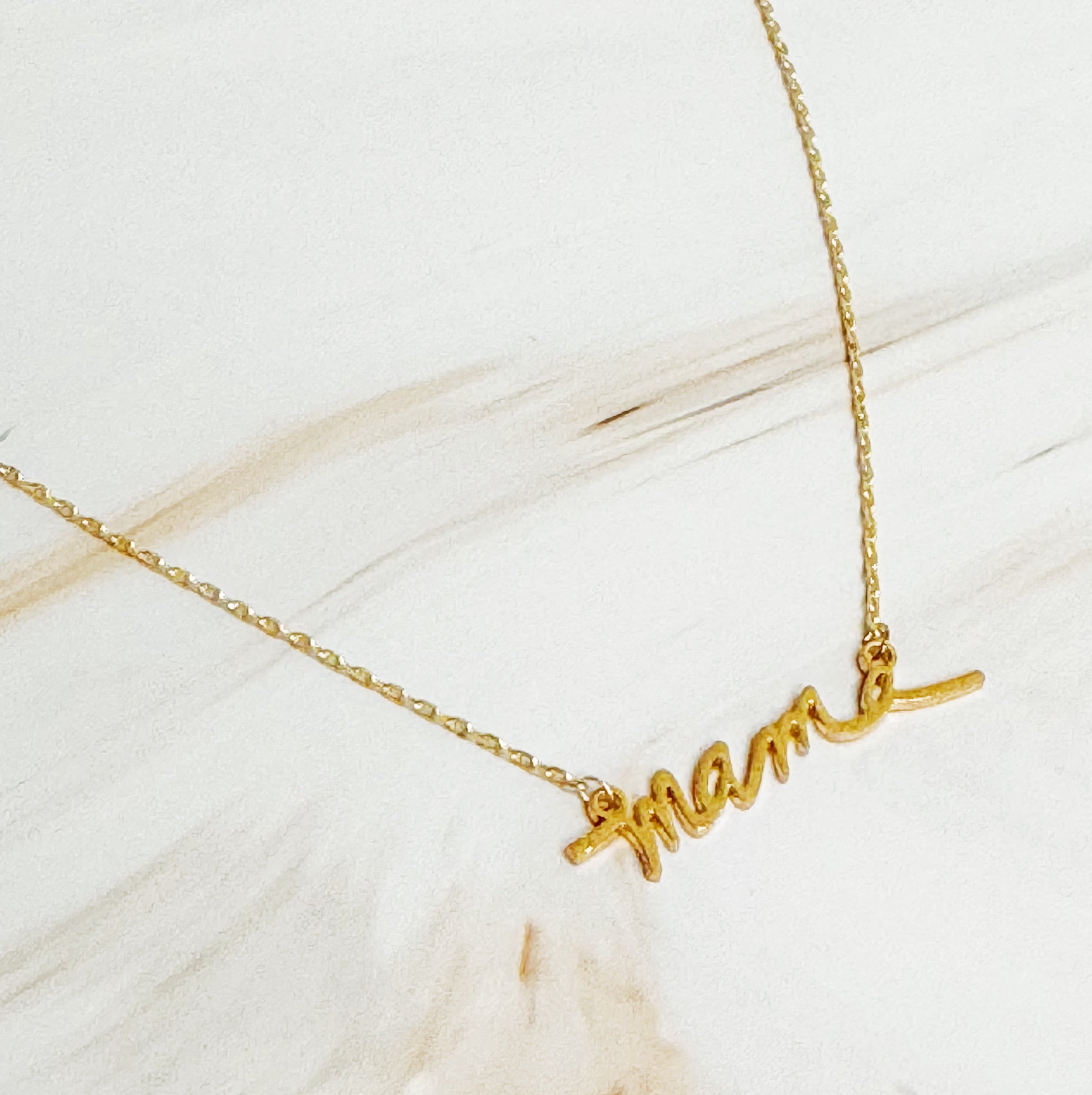Mama Script Necklace featuring the word 'mama' in elegant script font on a gold chain.