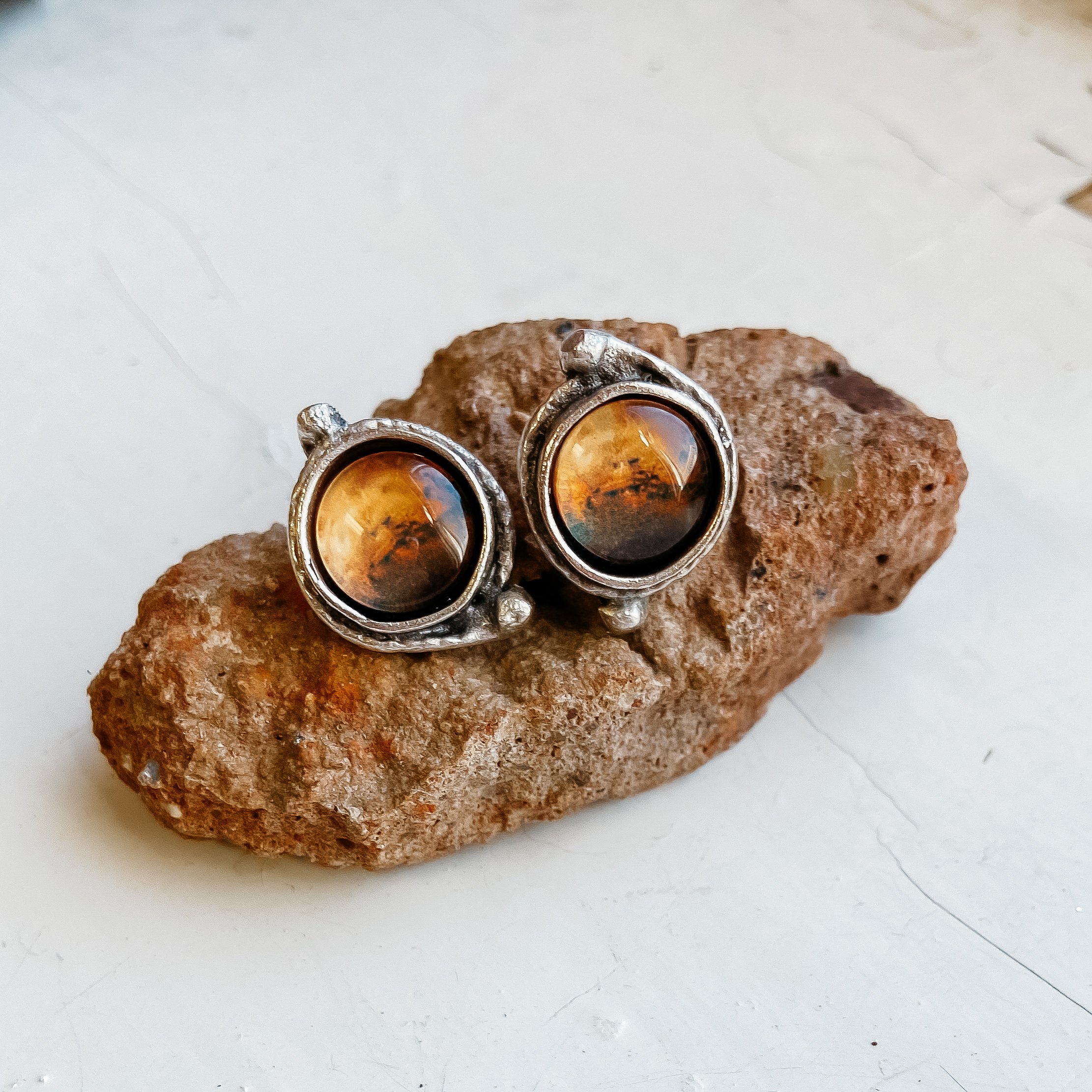 A pair of handcrafted Mars and Moons Earrings featuring the red planet Mars with silver beads representing its moons, Deimos and Phobos.