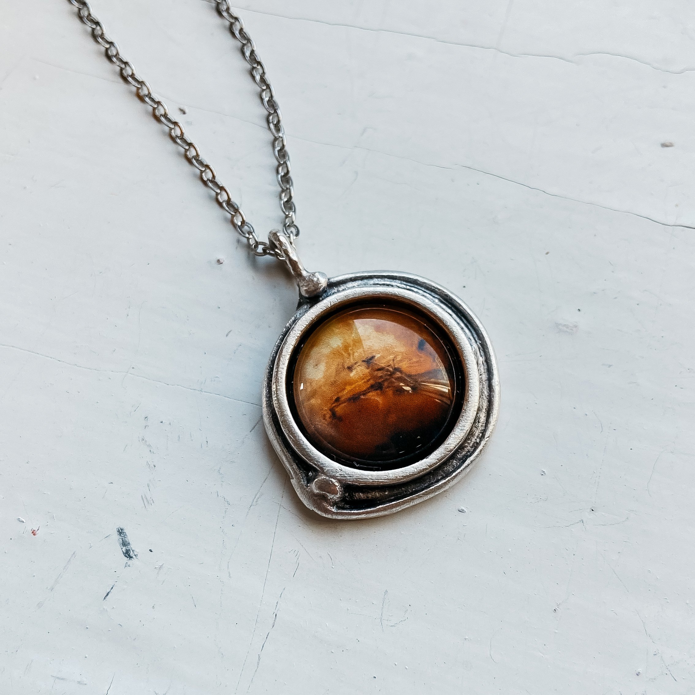 Handcrafted Mars and Moons Pendant Necklace featuring a silver tone Mars and orbiting beads representing Deimos and Phobos.
