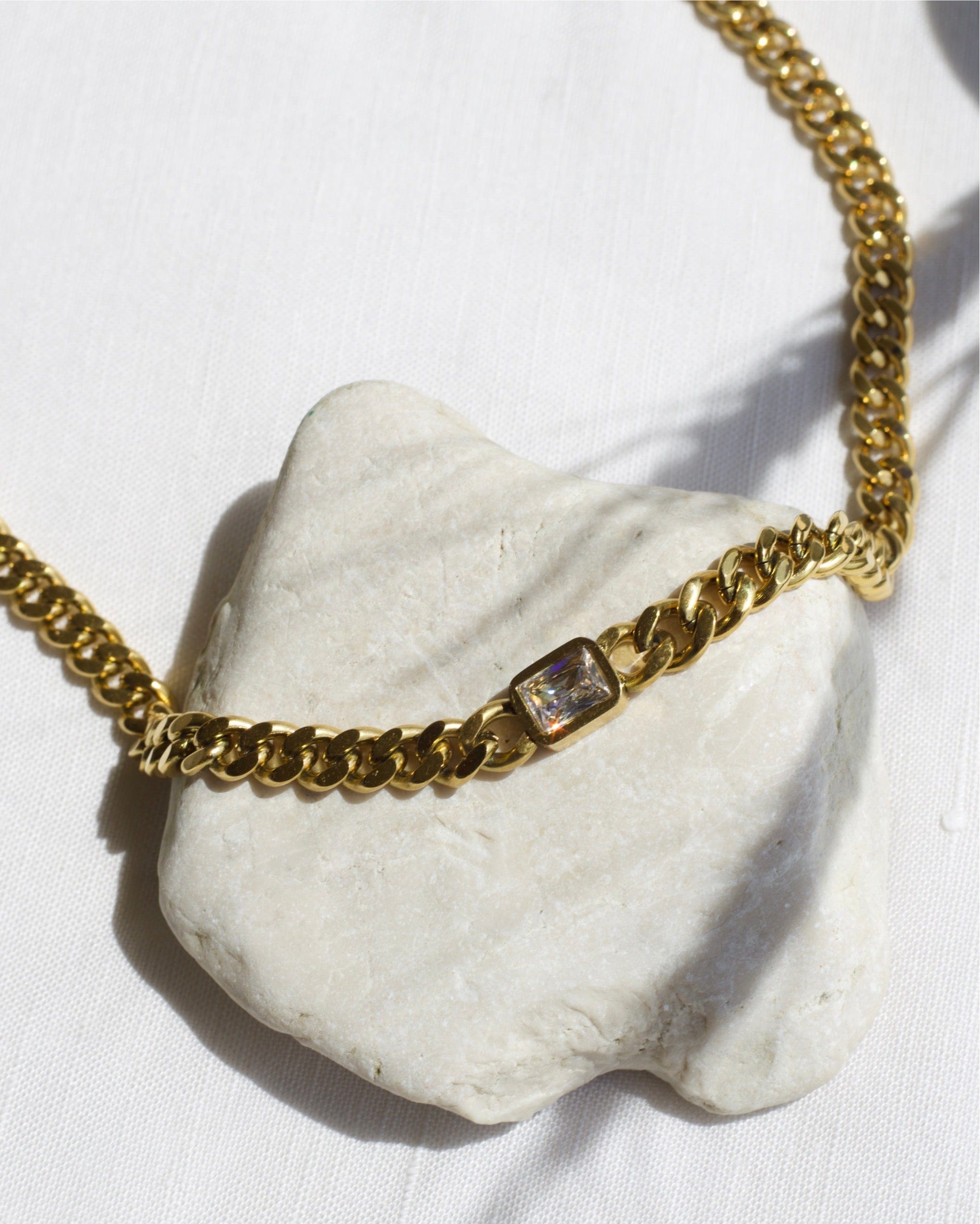 Martha Cuban Link Chain 8mm in rich gold with diamond cut emerald and clear CZ crystals, showcasing its chunky design and adjustable length.