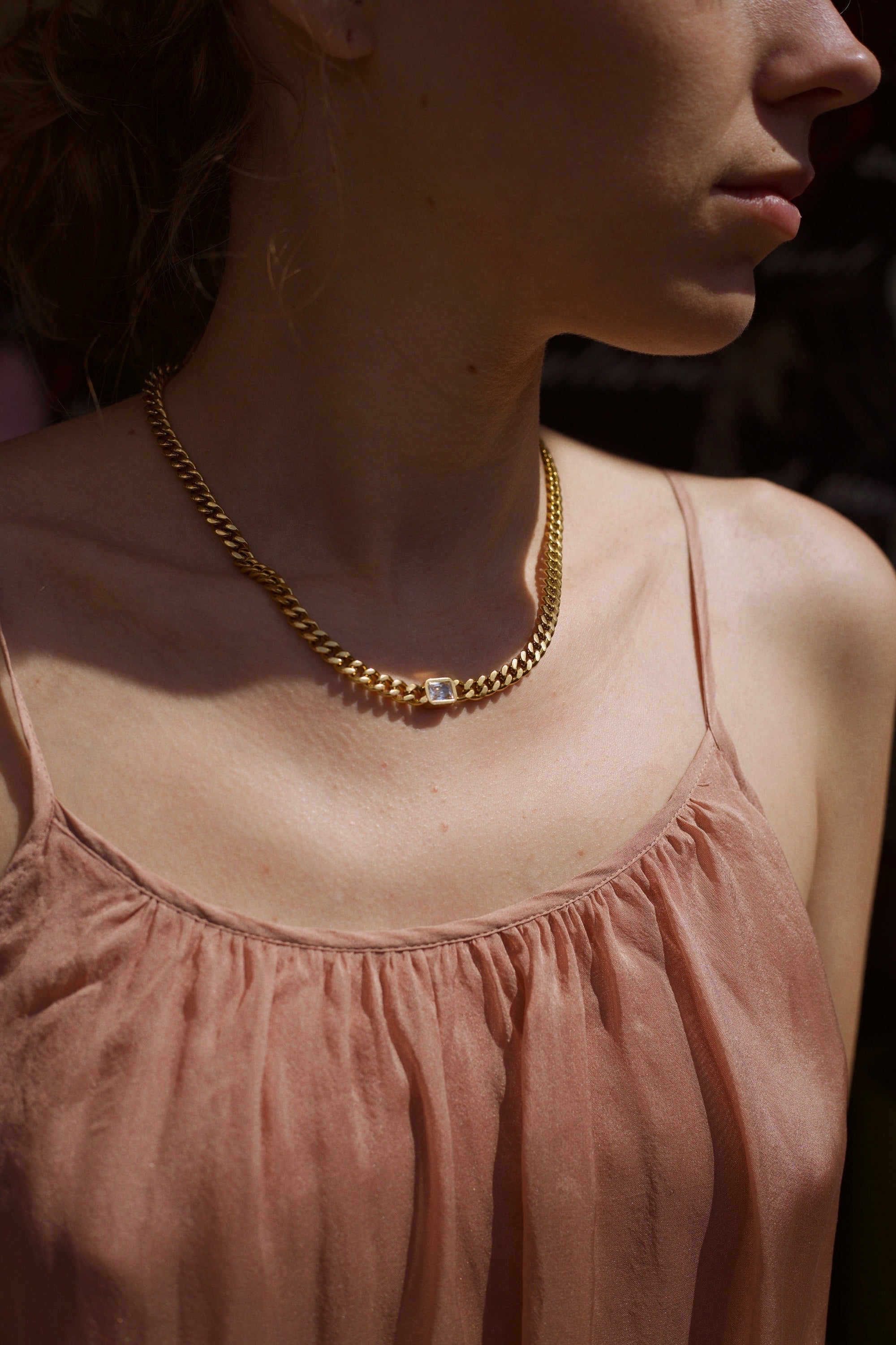 Martha Cuban Link Chain 8mm in rich gold with diamond cut emerald and clear CZ crystals, showcasing its chunky design and adjustable length.