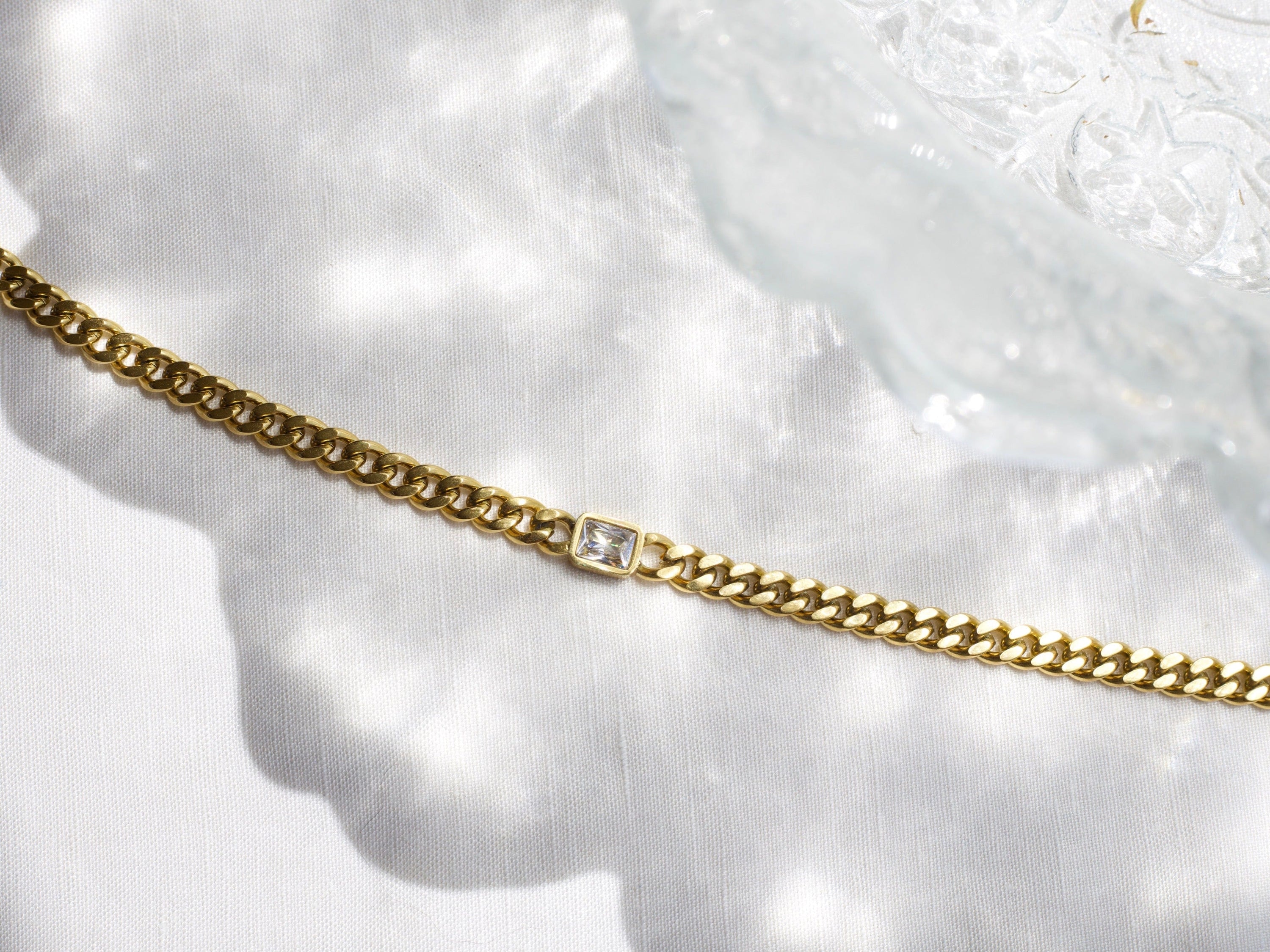 Martha Cuban Link Chain 8mm in rich gold with diamond cut emerald and clear CZ crystals, showcasing its chunky design and adjustable length.