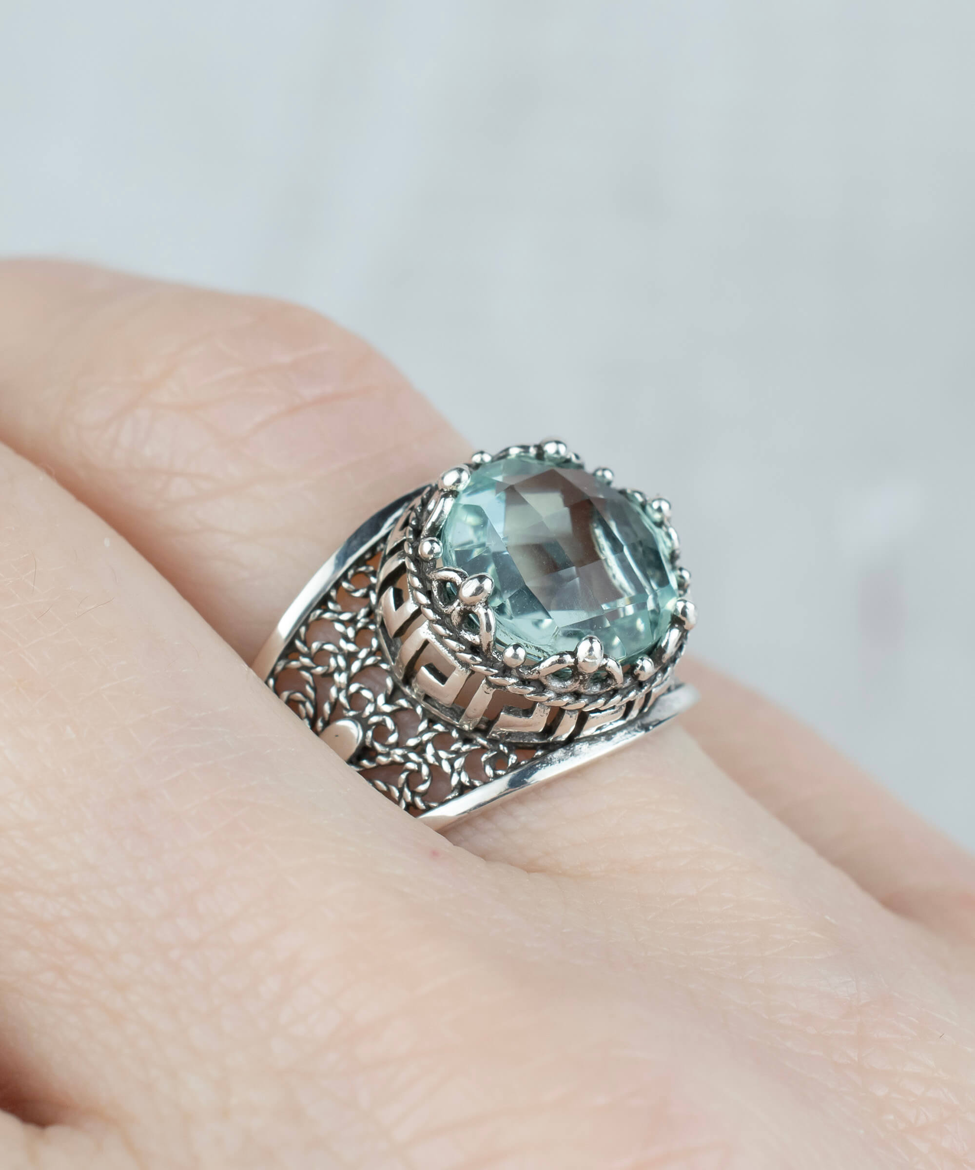 Elegant silver cocktail ring featuring aquamarine gemstone and intricate filigree art design, perfect for women.