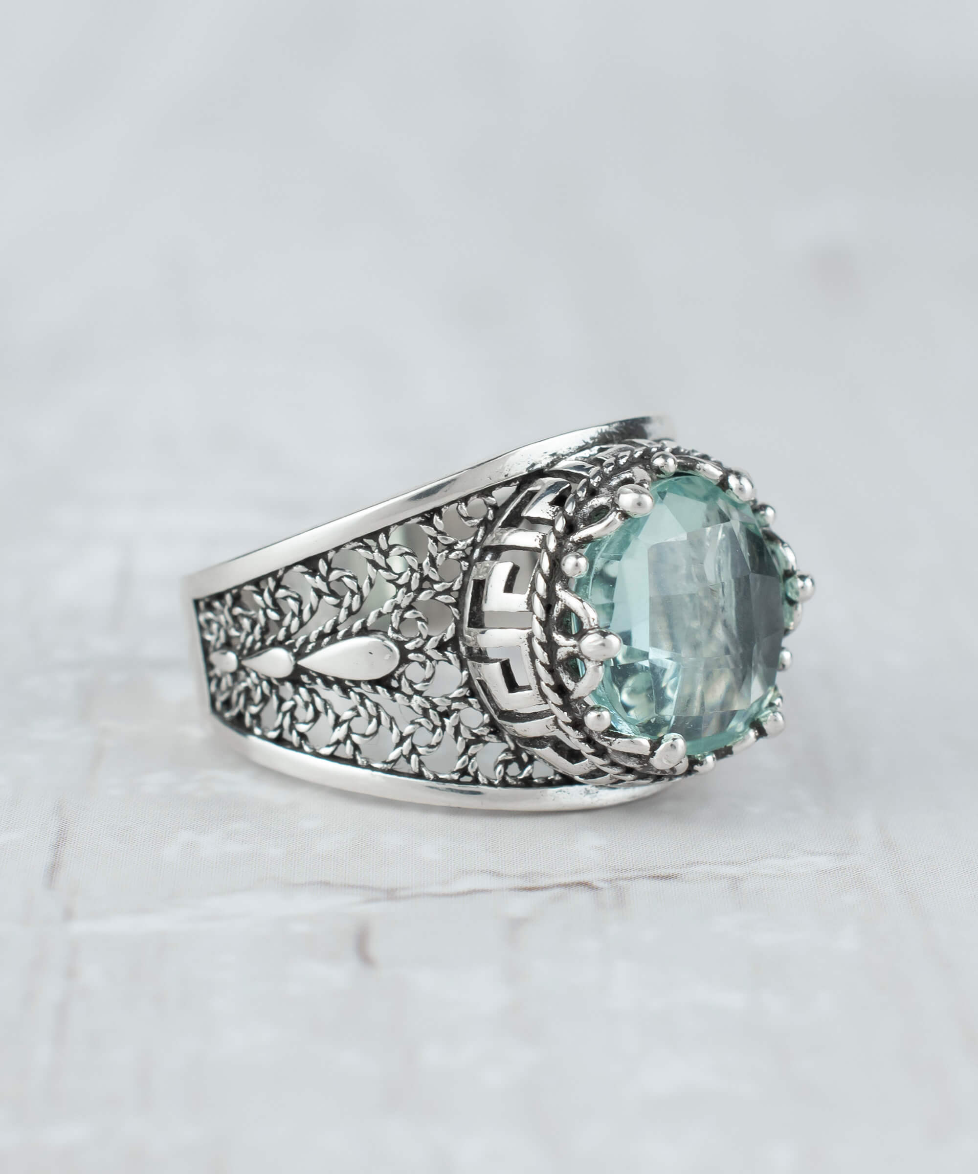 Elegant silver cocktail ring featuring aquamarine gemstone and intricate filigree art design, perfect for women.