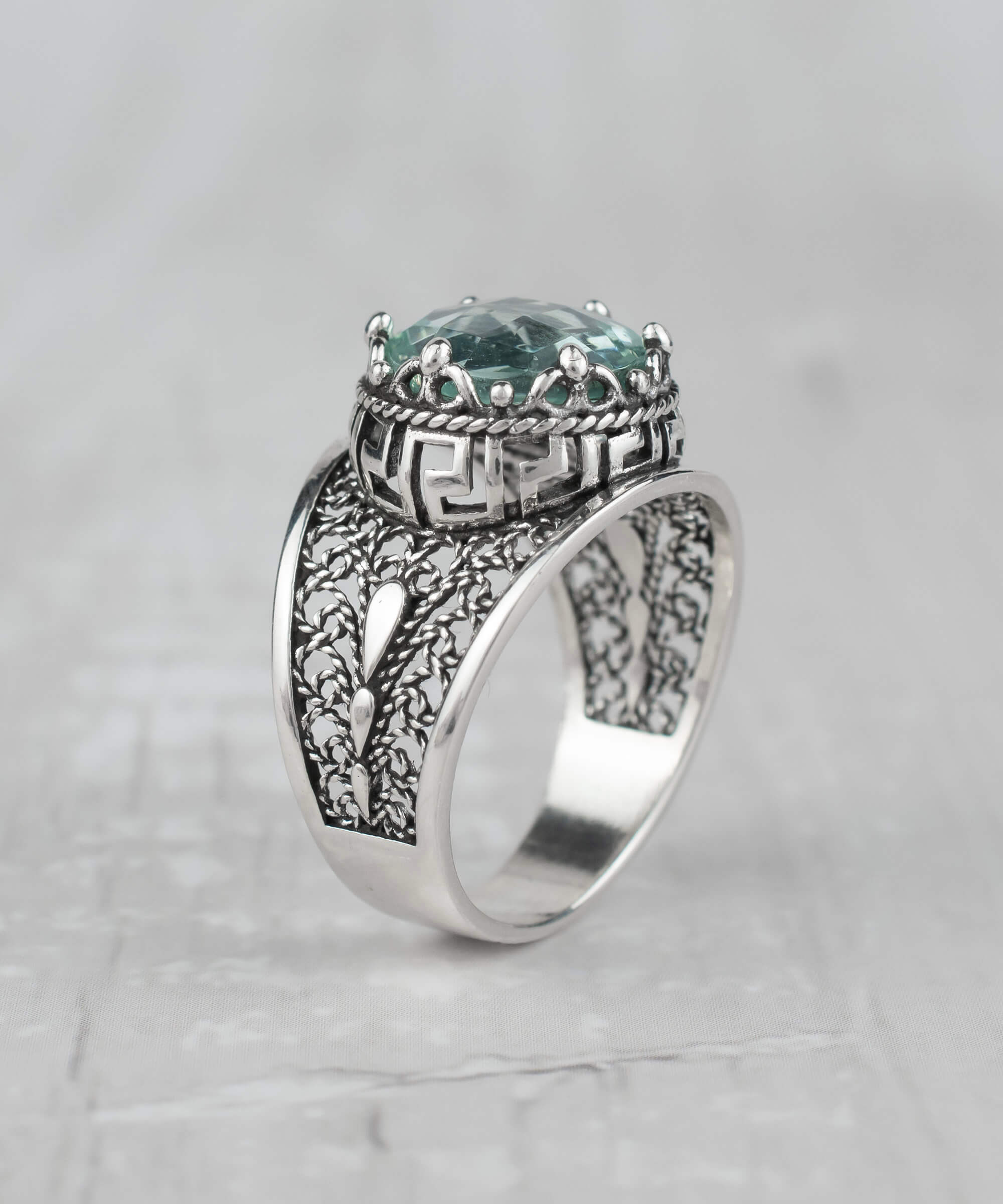 Elegant silver cocktail ring featuring aquamarine gemstone and intricate filigree art design, perfect for women.