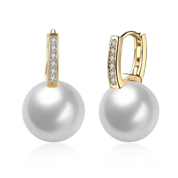 Micro-Pav'e Austrian Crystal Curved Pearl Huggie Earrings set in 18K gold, showcasing their elegant design and sparkling crystals.