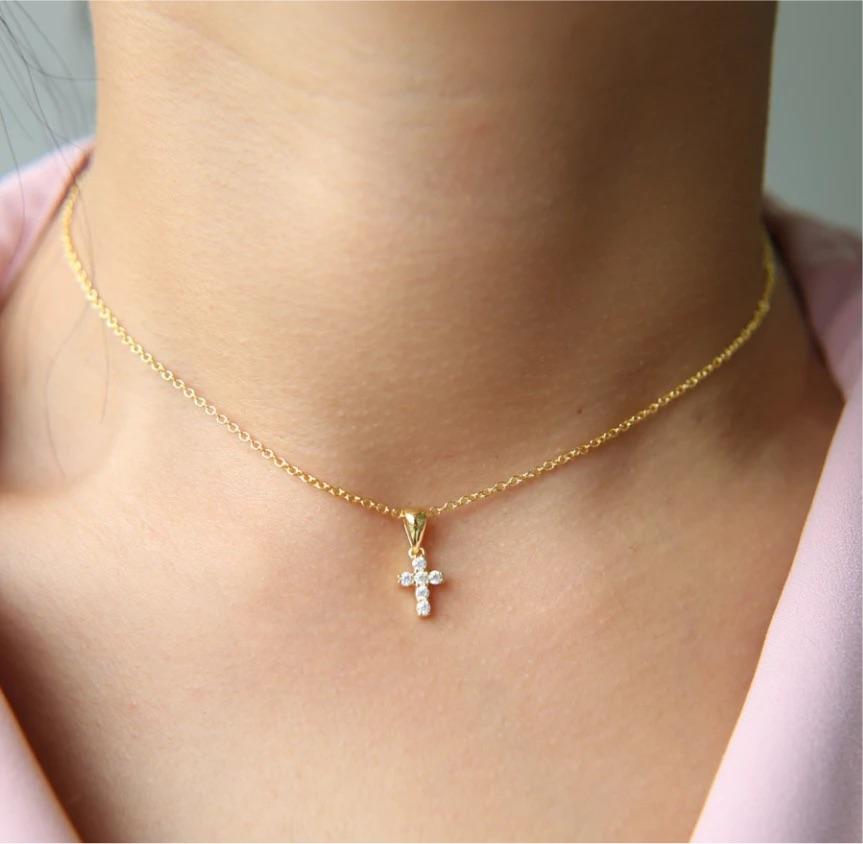 A delicate Mini Cross Necklace featuring a 14mm cross charm, adjustable length with a 3-inch extender, perfect for layering or solo wear.