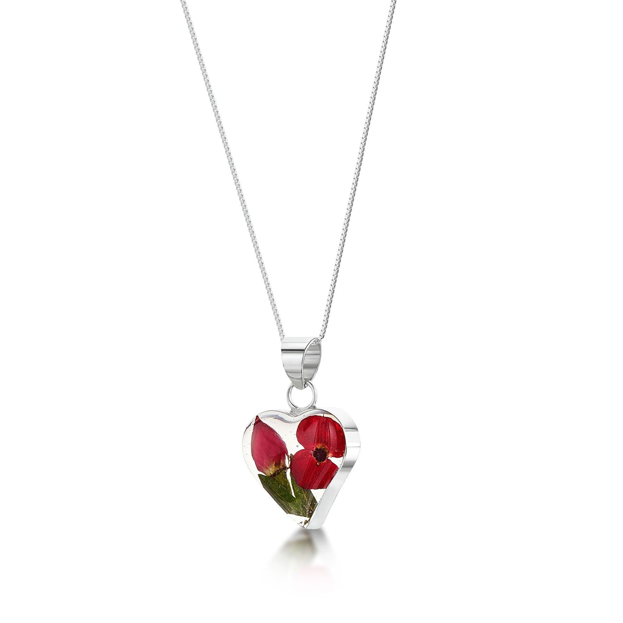 A beautiful heart pendant necklace featuring real miniature rose and poppy flowers, set in sterling silver with an adjustable chain.