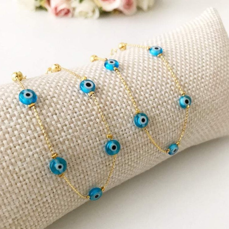 Minimalist Evil Eye Bracelet featuring turquoise beads and a delicate gold chain, showcasing five tiny glass evil eye beads.