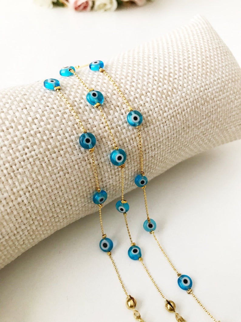 Minimalist Evil Eye Bracelet featuring turquoise beads and a delicate gold chain, showcasing five tiny glass evil eye beads.