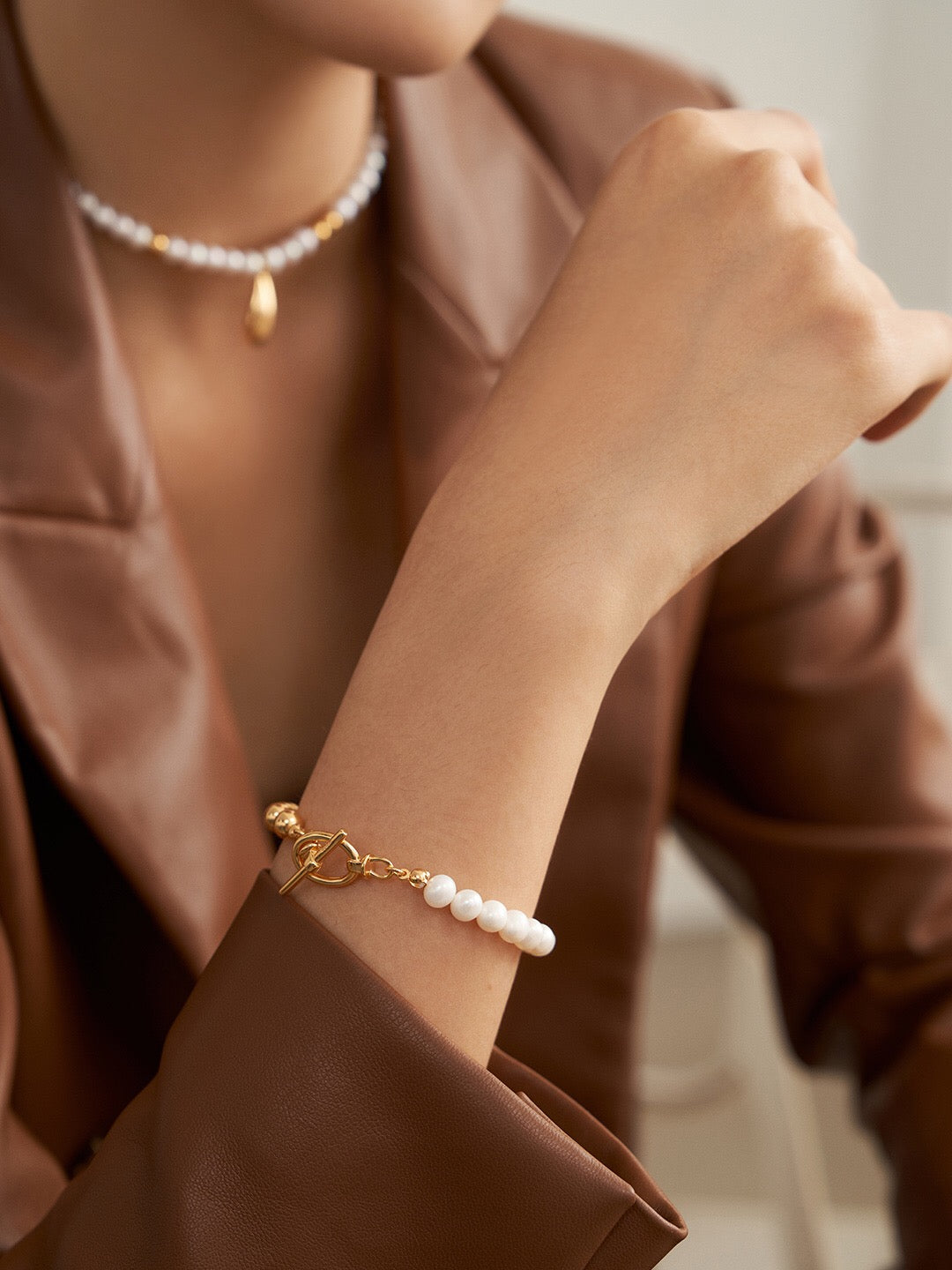 A delicate Minimalist Half Beaded Pearl Bracelet featuring genuine freshwater pearls and gold vermeil accents, elegantly displayed on a soft surface.