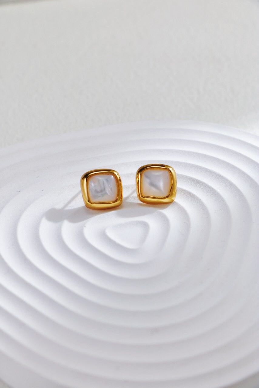 A pair of elegant Minimalist Mother-Of-Pearl Stud Earrings featuring gold vermeil, showcasing their handcrafted design and lustrous finish.