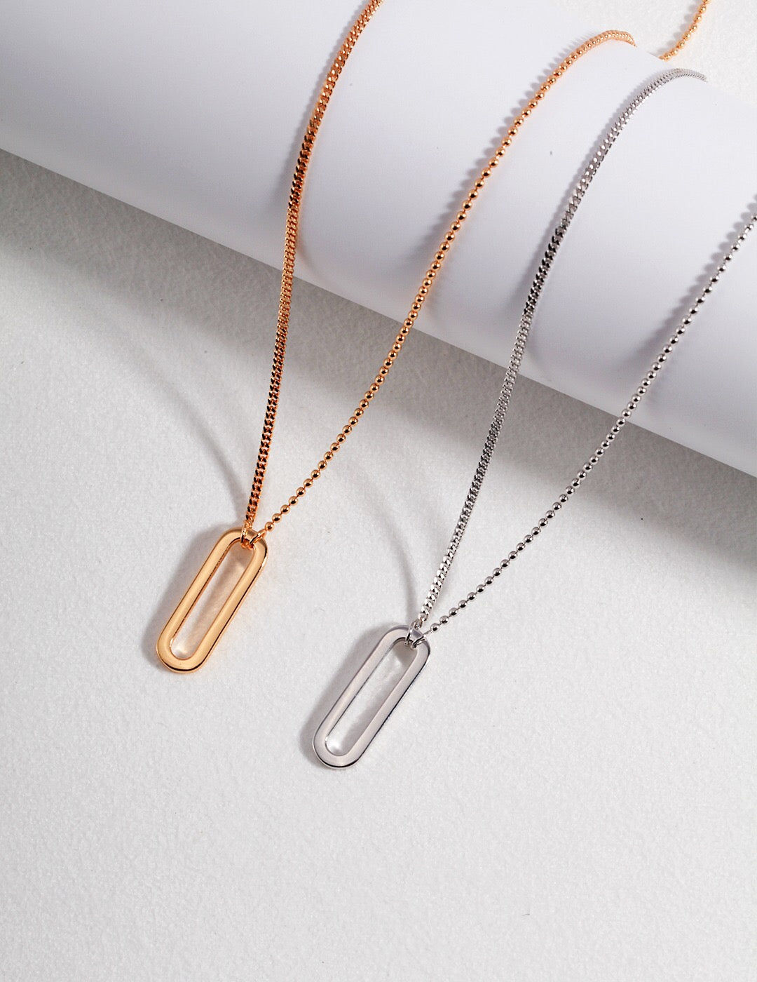 A delicate Minimalist Paperclip Necklace made of gold vermeil, featuring a sleek paperclip pendant on an adjustable chain.