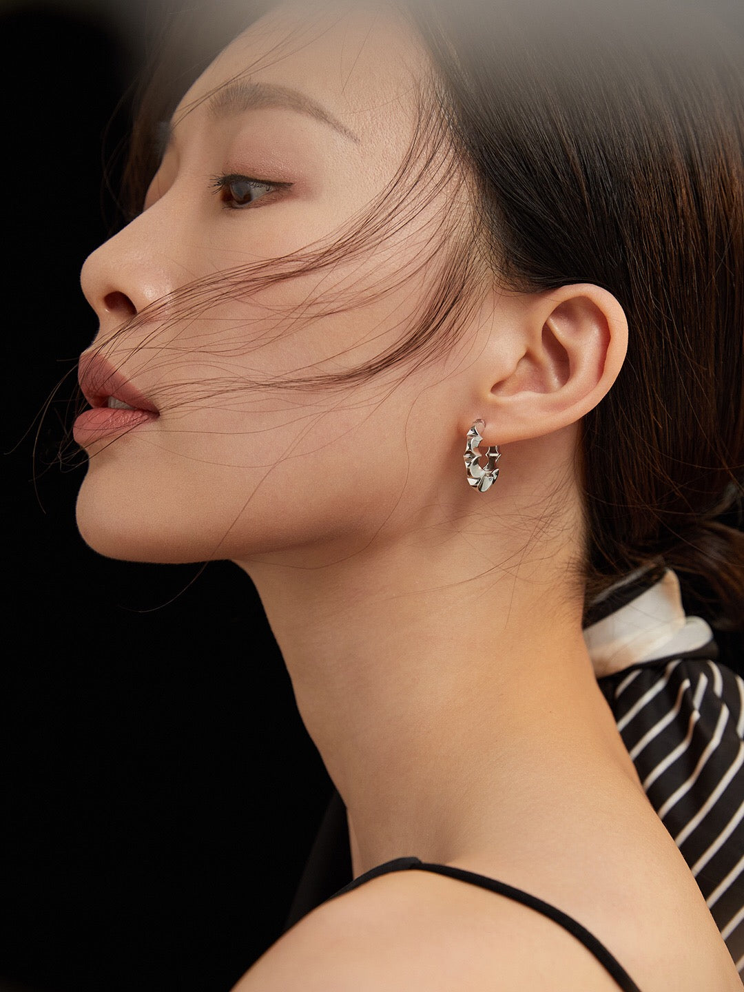 A pair of elegant Minimalist Petal Hoop Earrings made from sterling silver with a gold vermeil finish, showcasing their delicate petal design.