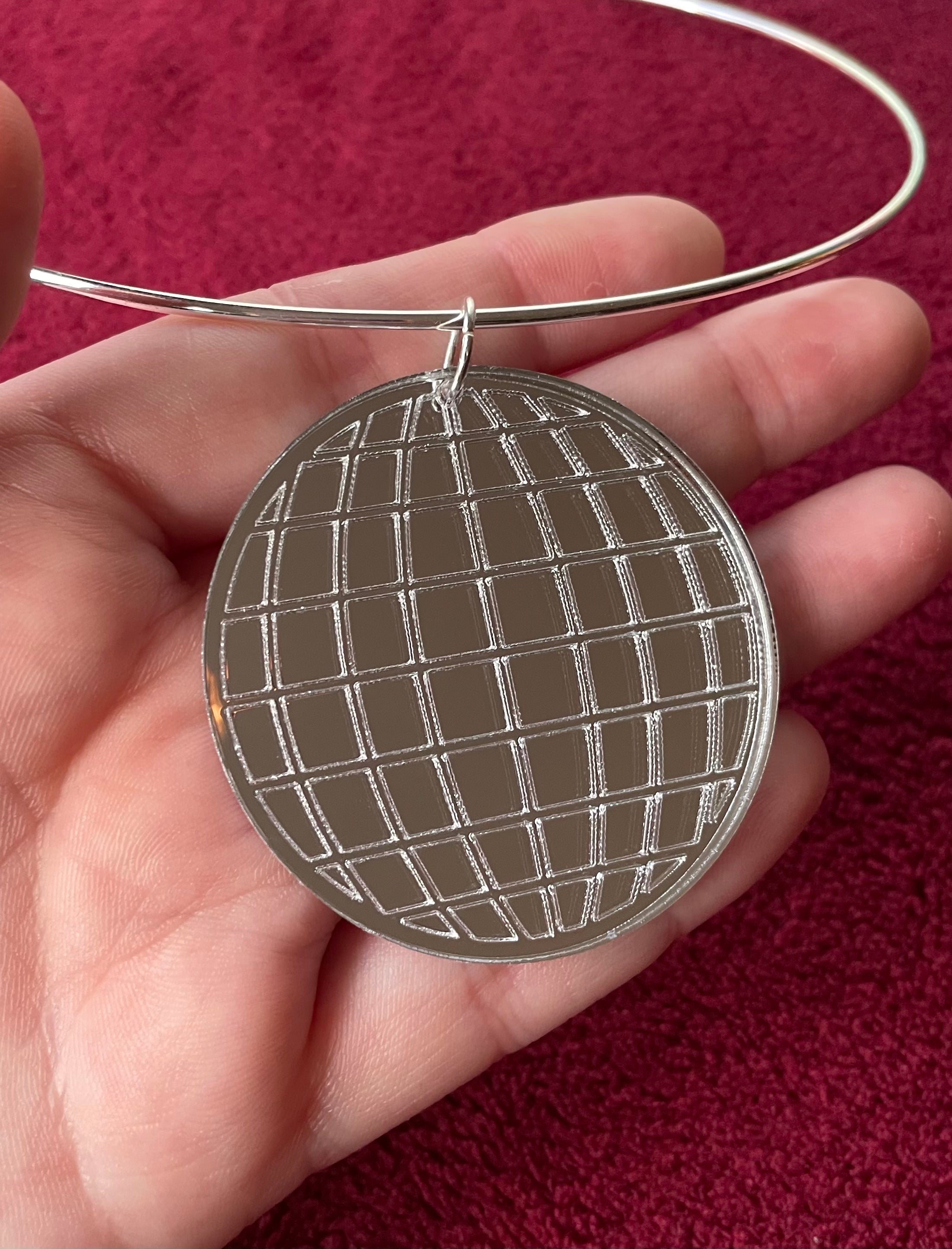 A stylish Mirror Ball Choker featuring a shiny mirror ball pendant, customizable colors, and a retro-inspired design.