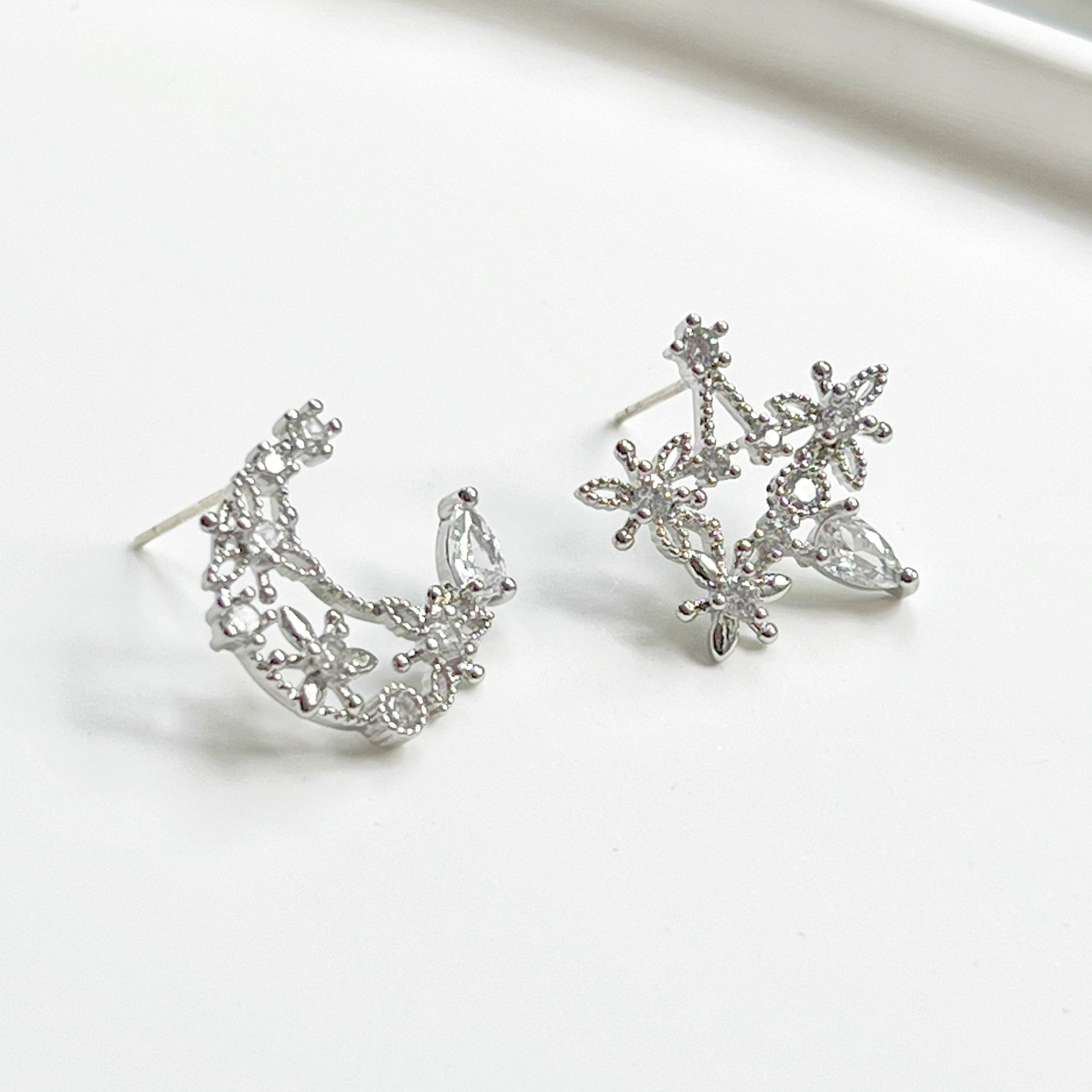 Elegant Moon and Star Earrings featuring teardrop crystals, crafted from sterling silver and silver-plated bronze.