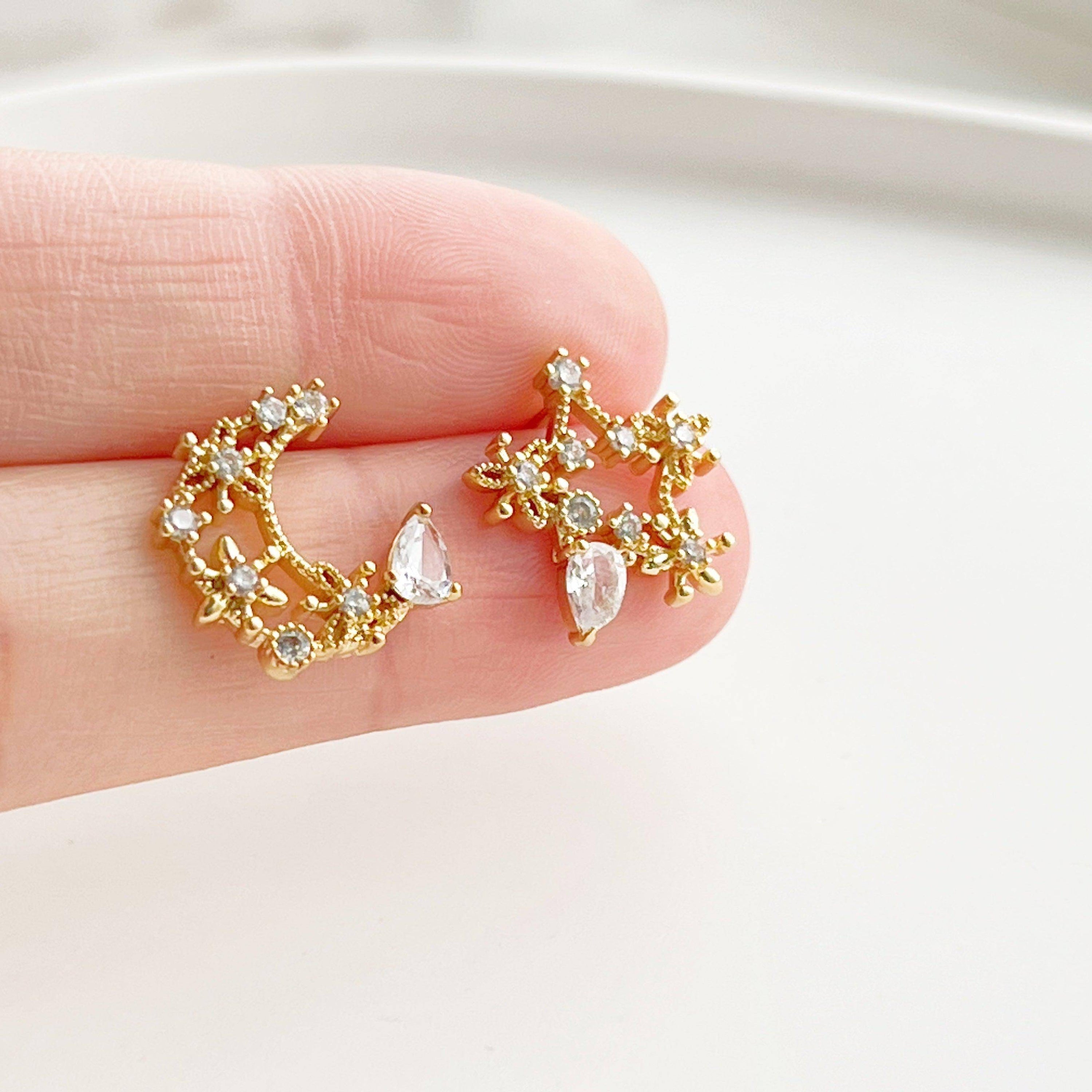 Elegant Moon and Star Earrings featuring teardrop crystals, crafted from sterling silver and silver-plated bronze.