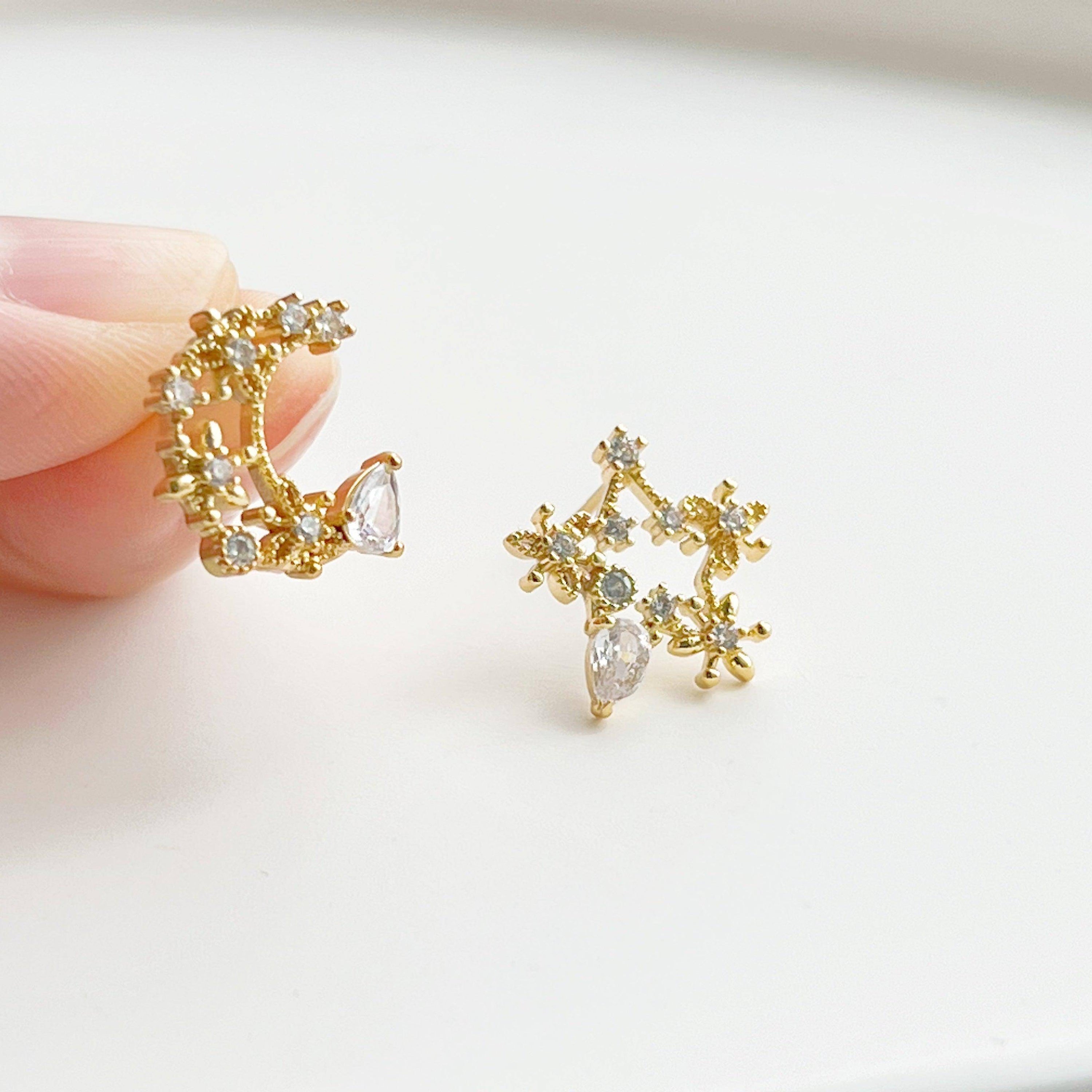 Elegant Moon and Star Earrings featuring teardrop crystals, crafted from sterling silver and silver-plated bronze.