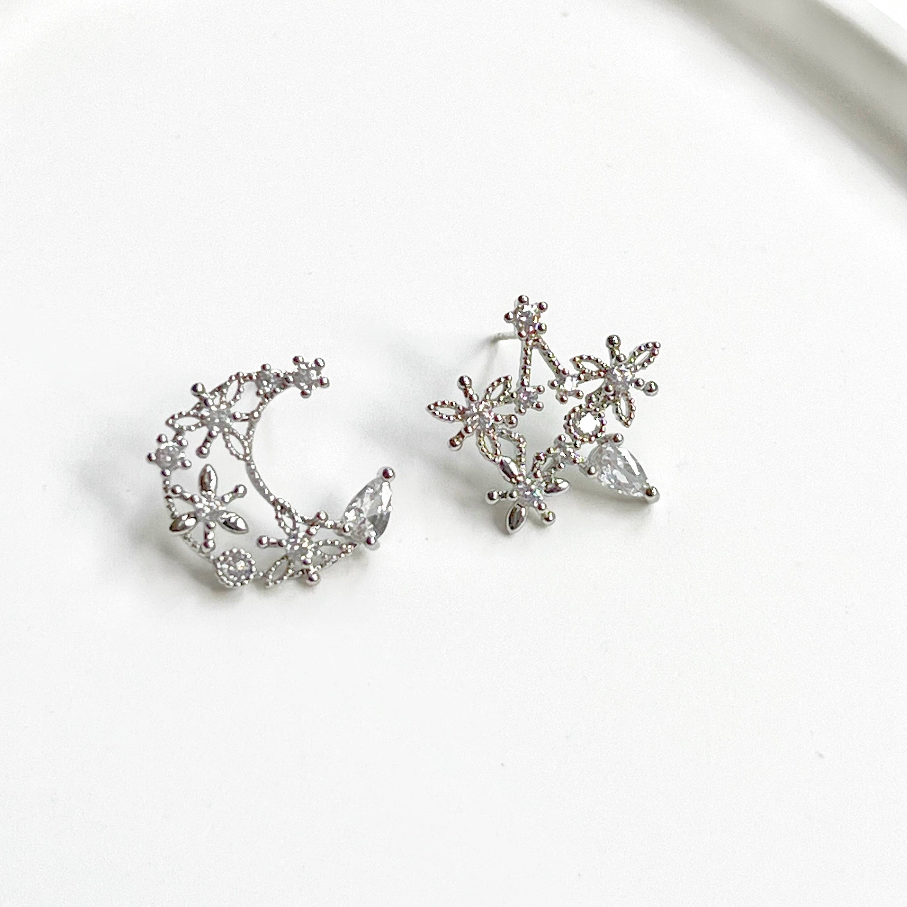 Elegant Moon and Star Earrings featuring teardrop crystals, crafted from sterling silver and silver-plated bronze.