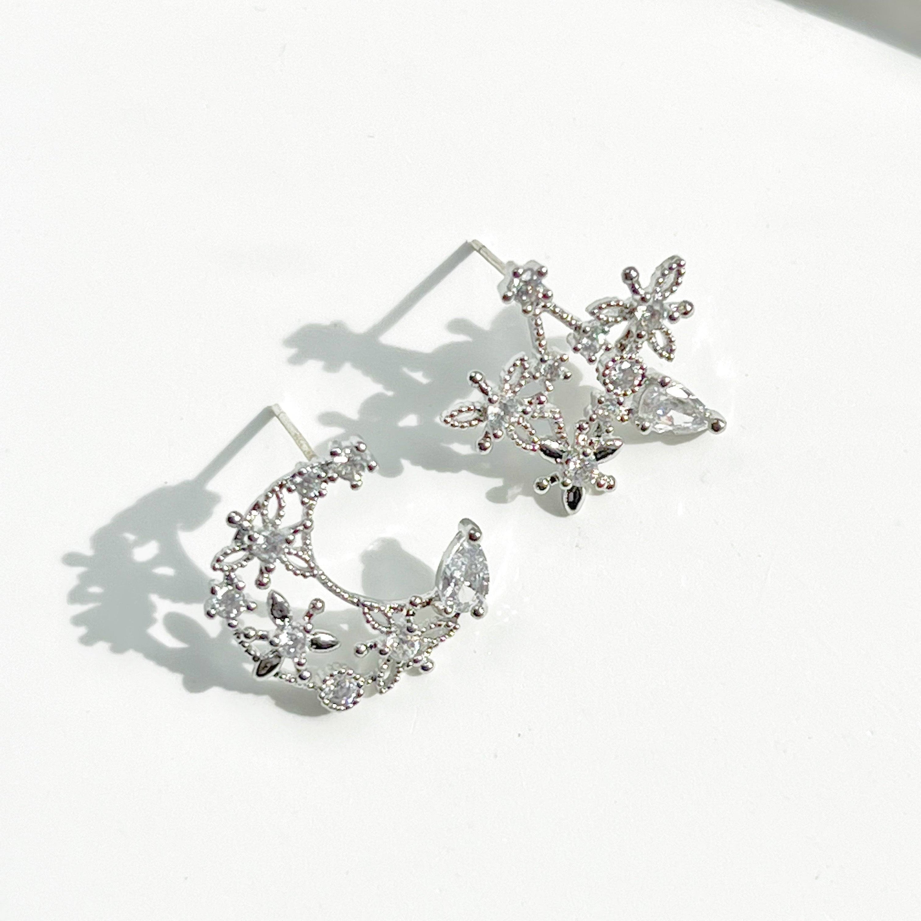 Elegant Moon and Star Earrings featuring teardrop crystals, crafted from sterling silver and silver-plated bronze.