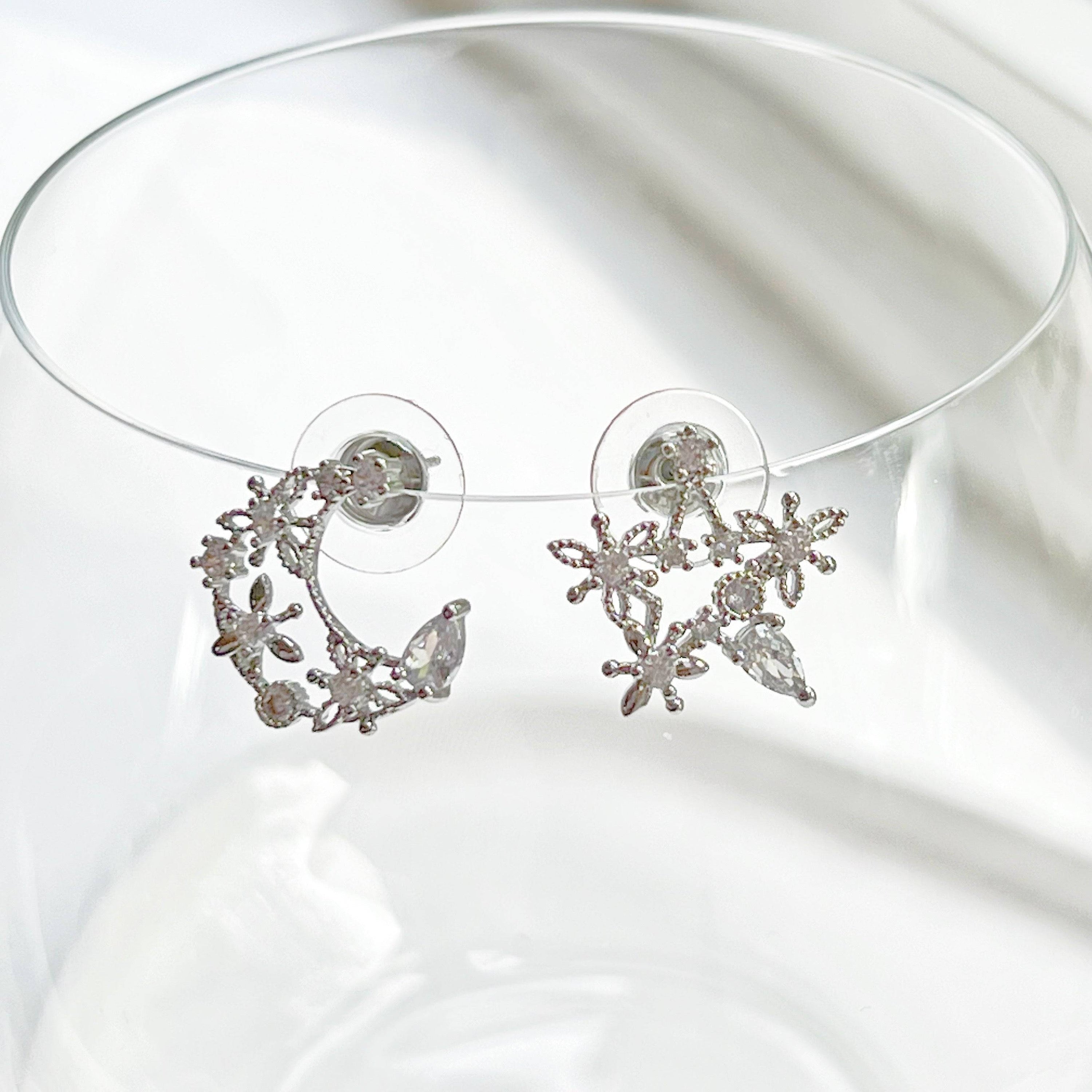 Elegant Moon and Star Earrings featuring teardrop crystals, crafted from sterling silver and silver-plated bronze.