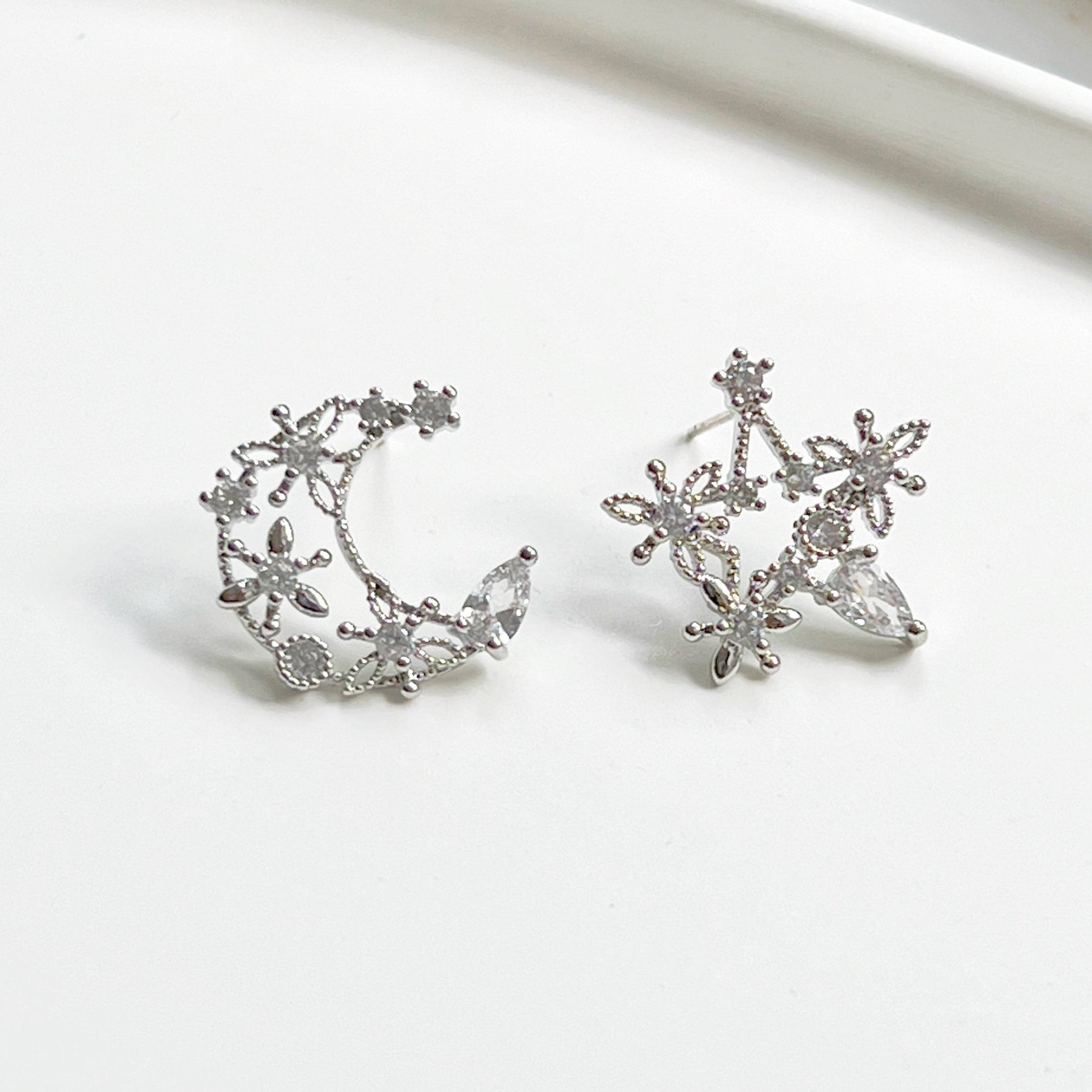 Elegant Moon and Star Earrings featuring teardrop crystals, crafted from sterling silver and silver-plated bronze.
