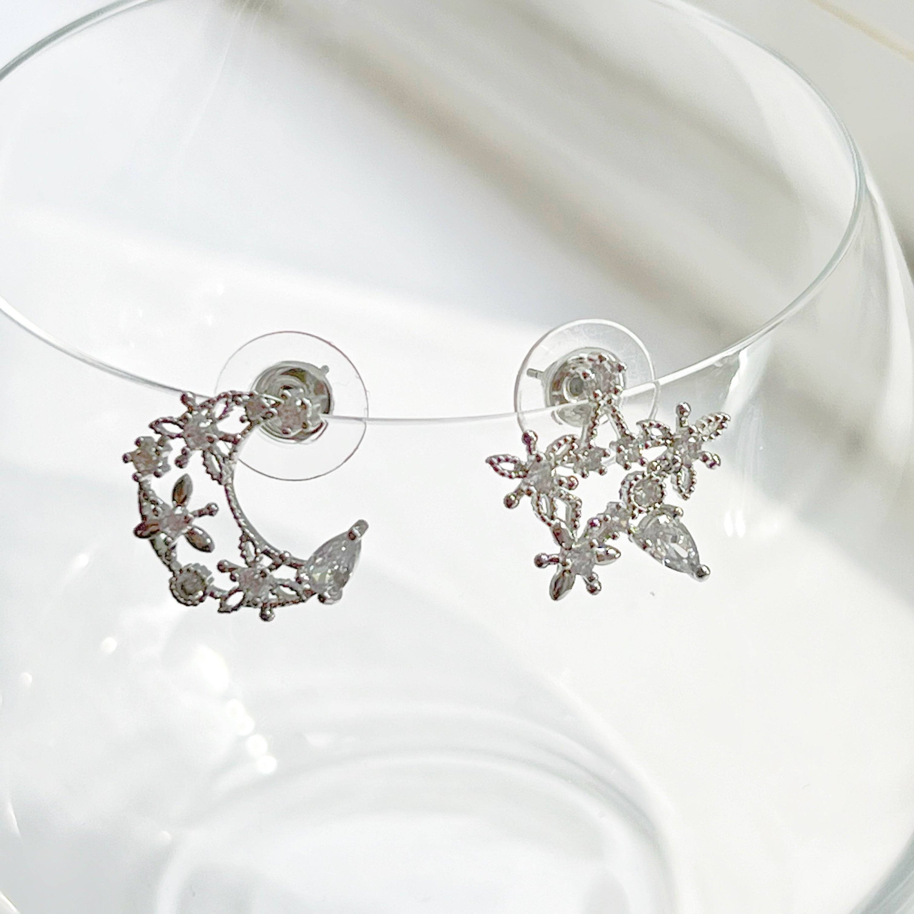 Elegant Moon and Star Earrings featuring teardrop crystals, crafted from sterling silver and silver-plated bronze.
