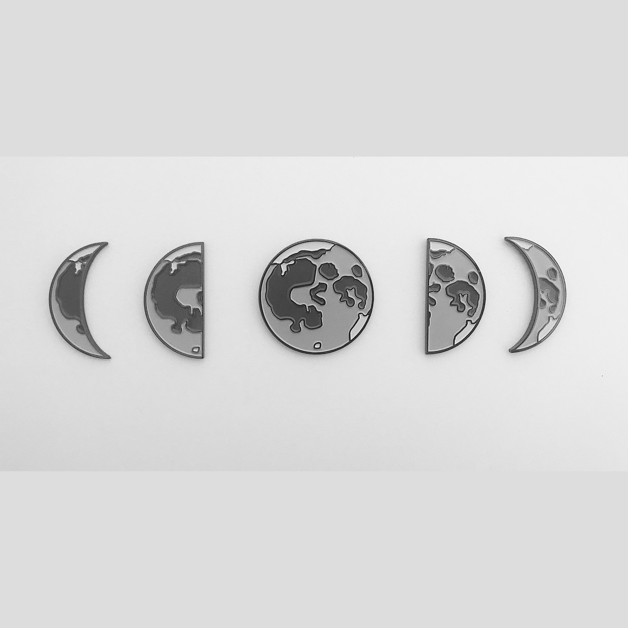 Moon Phases Enamel Pin Set of 5 featuring various moon phases including waxing and waning crescents, quarter moons, and a full moon.