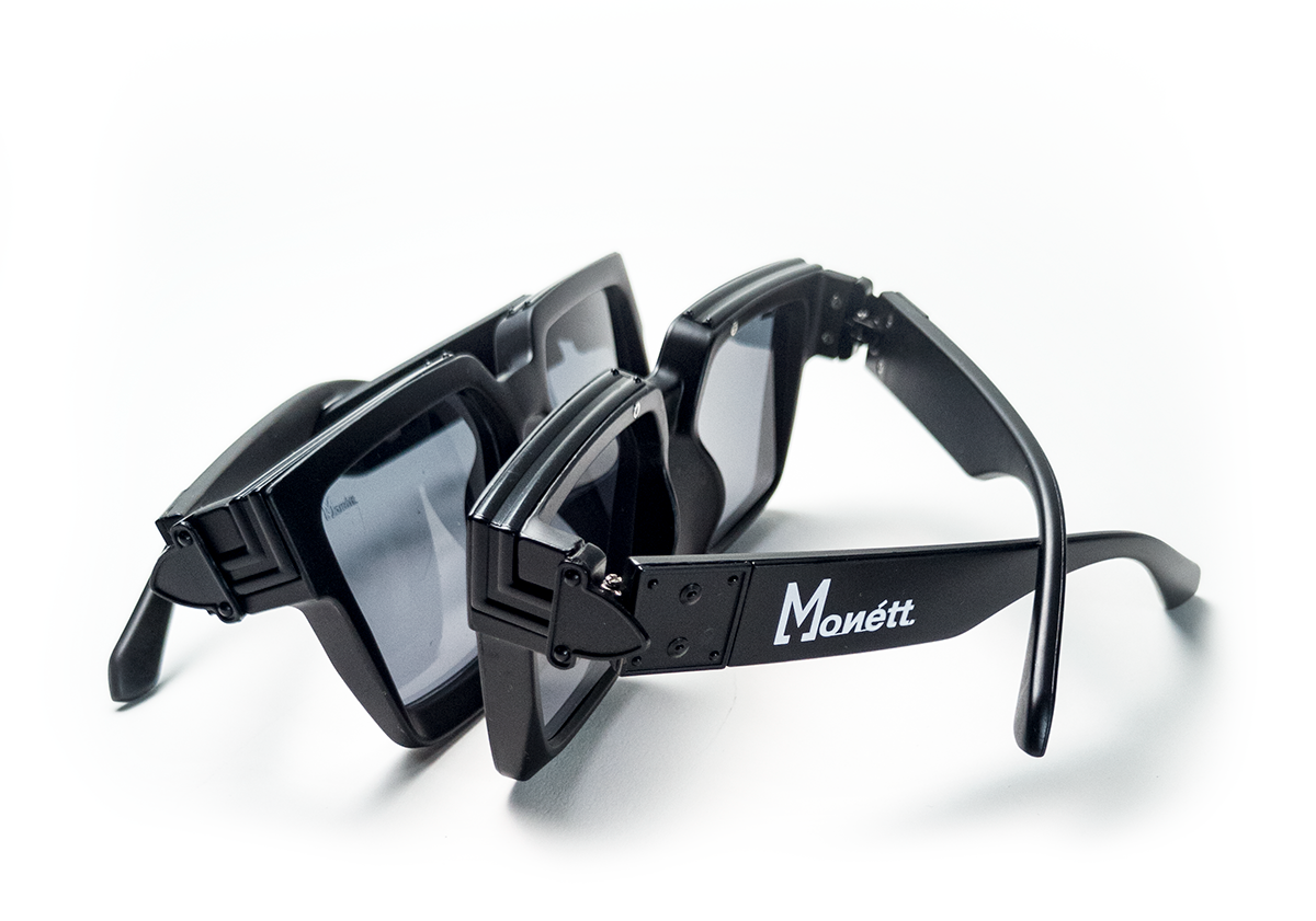 Monett Manifesto Black sunglasses featuring a stylish square frame and gradient lenses, perfect for outdoor activities.