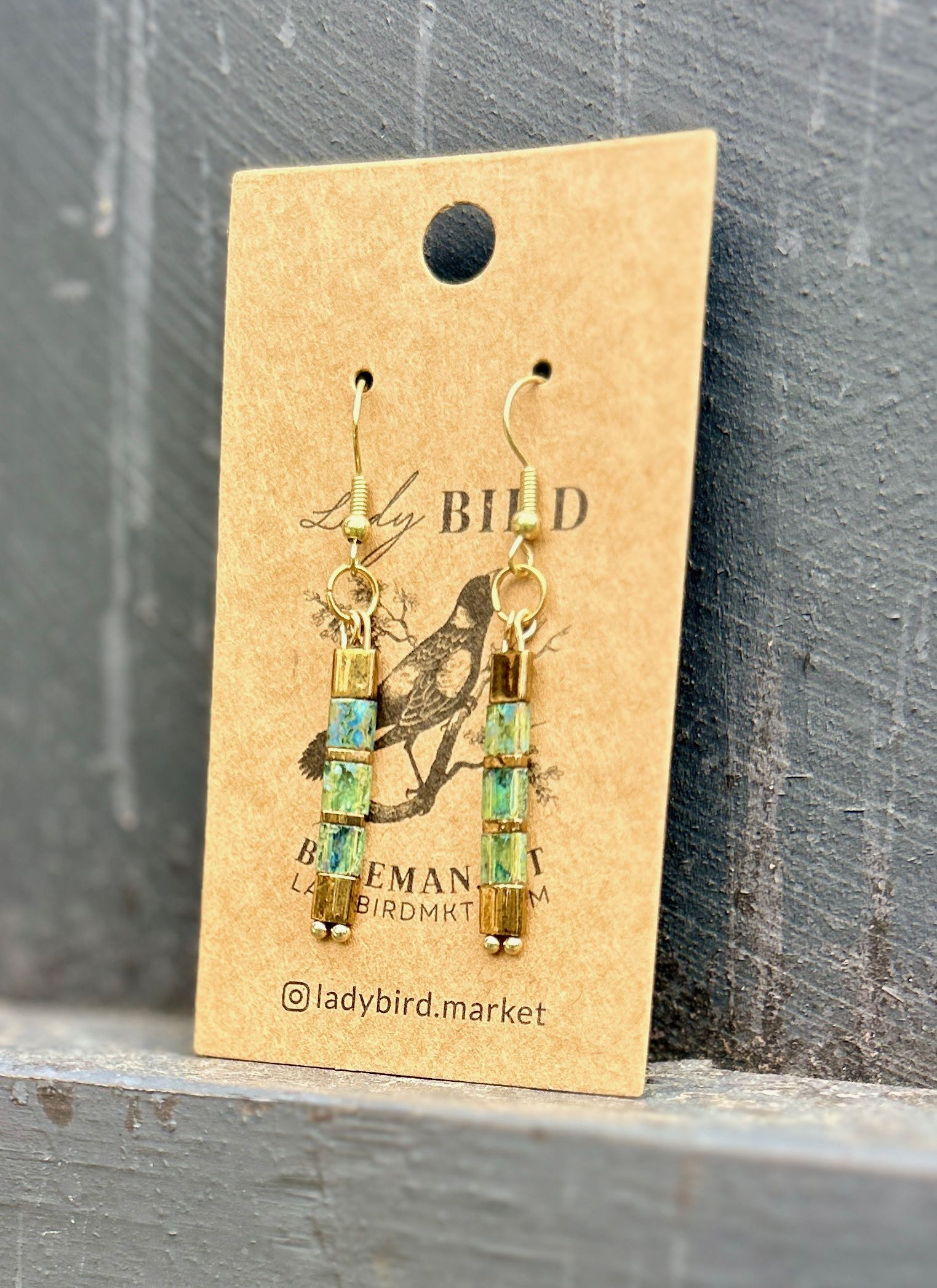 Mossy speckled green and gold Tila bead earrings, showcasing a unique bohemian design with high-quality craftsmanship.