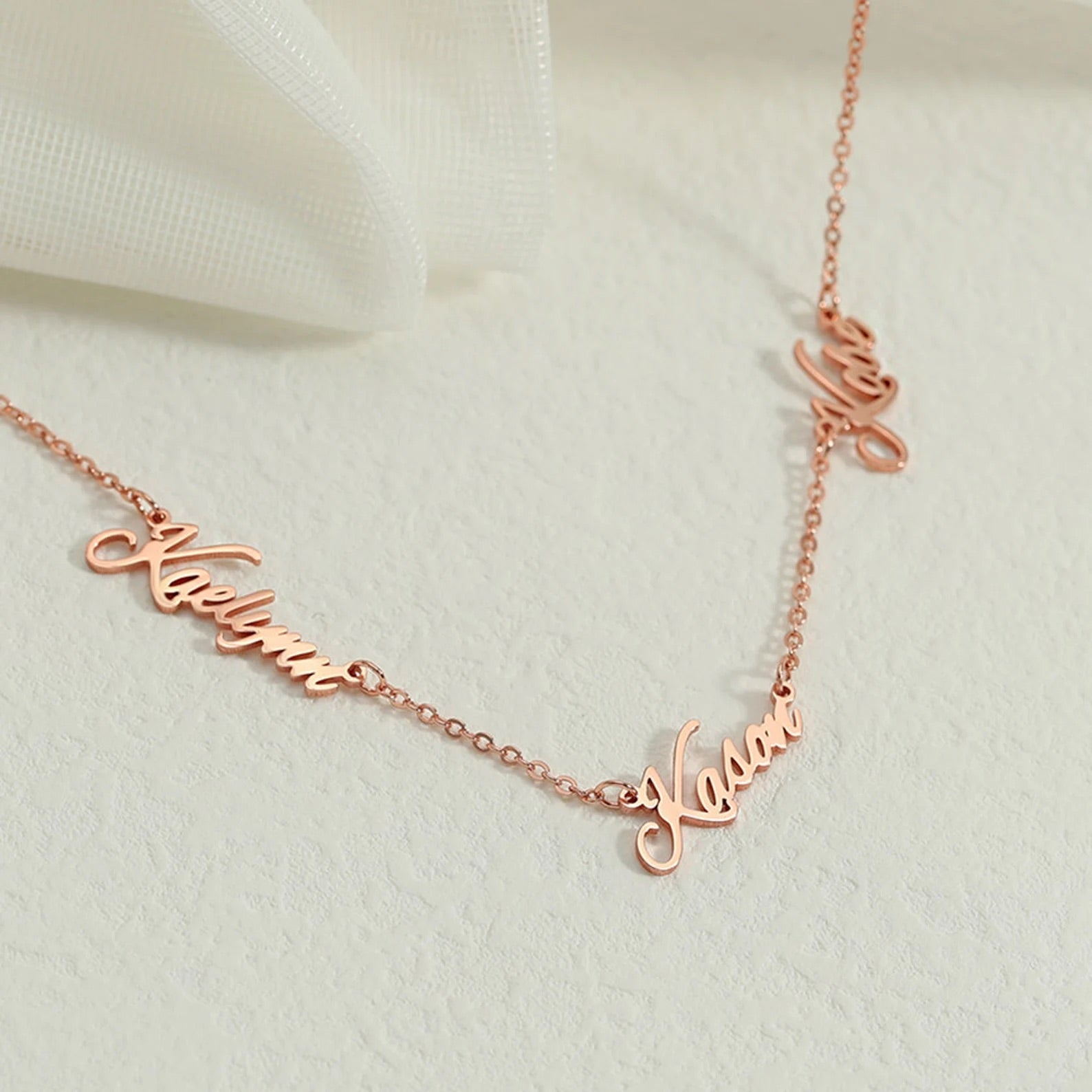 A personalized Multiple Name Necklace in gold, silver, and rose gold, showcasing customizable names in elegant fonts.