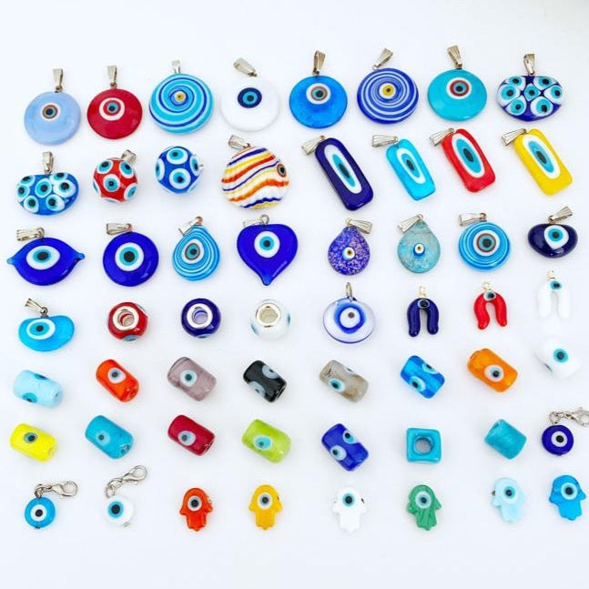 Handmade Murano Evil Eye Bead pendant in vibrant blue and red colors, showcasing intricate lampwork design.