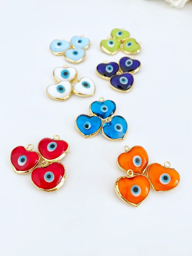 A collection of Murano Evil Eye Beads featuring glass heart designs in various colors, showcasing their unique charm and craftsmanship.