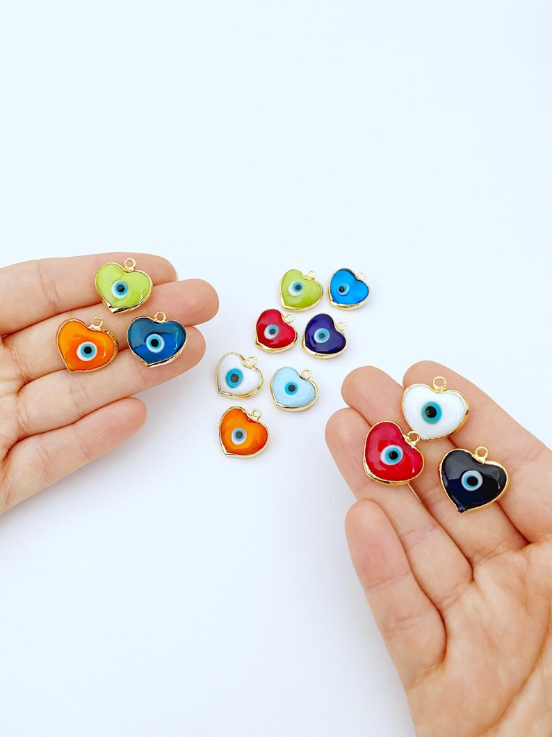 A collection of Murano Evil Eye Beads featuring glass heart designs in various colors, showcasing their unique charm and craftsmanship.