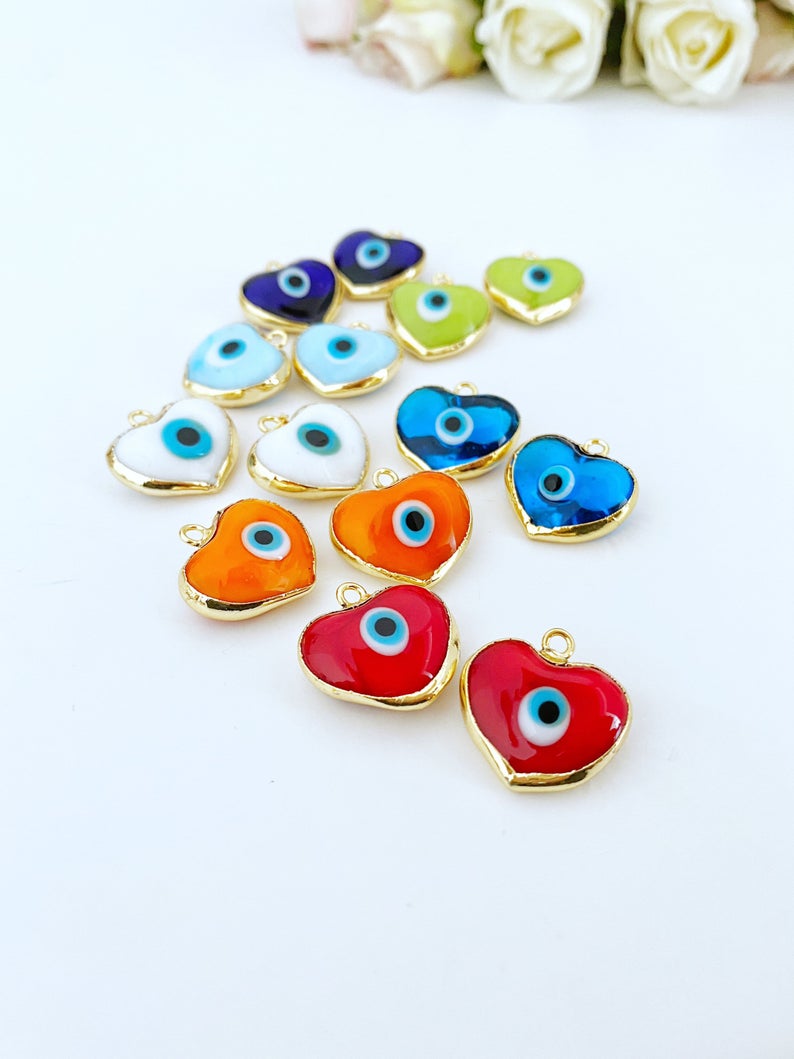 A collection of Murano Evil Eye Beads featuring glass heart designs in various colors, showcasing their unique charm and craftsmanship.