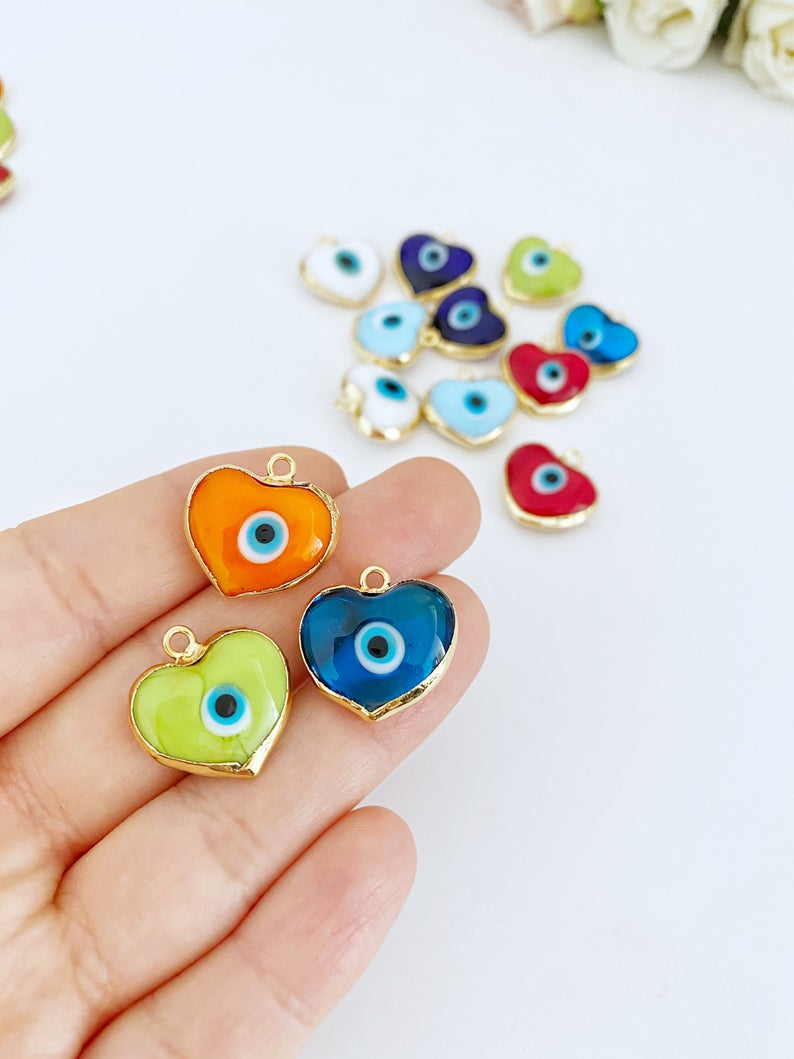 A collection of Murano Evil Eye Beads featuring glass heart designs in various colors, showcasing their unique charm and craftsmanship.