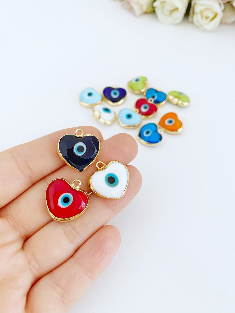 A collection of Murano Evil Eye Beads featuring glass heart designs in various colors, showcasing their unique charm and craftsmanship.