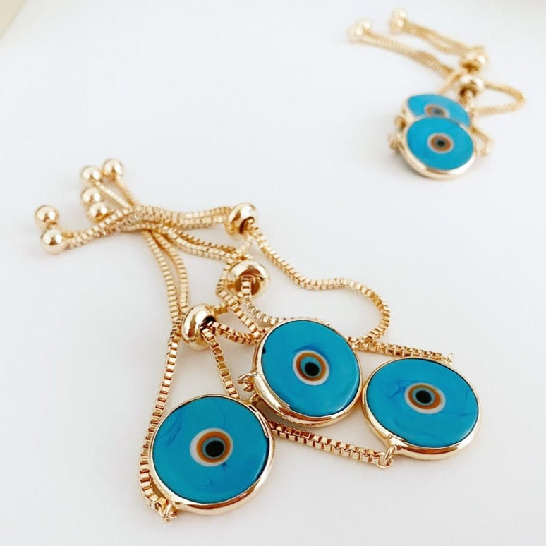 Murano Evil Eye Bracelet featuring a baby blue charm and adjustable rose gold design, showcasing its handmade craftsmanship.