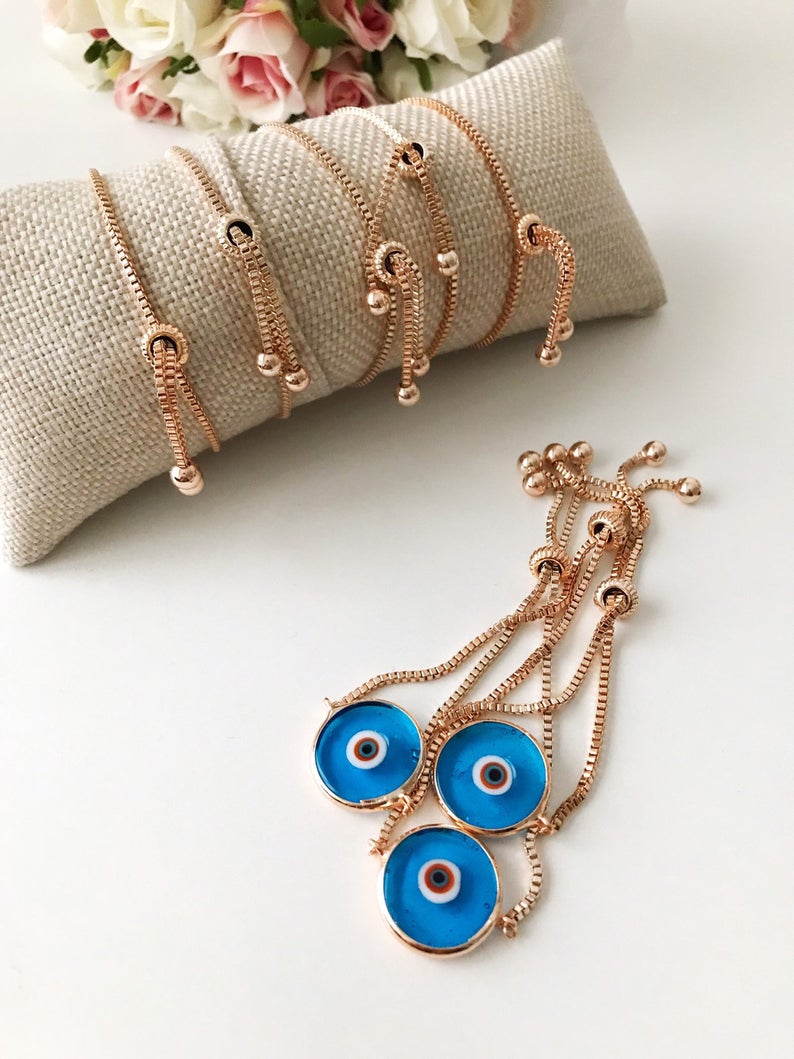 Murano Evil Eye Bracelet featuring a turquoise charm on an adjustable rose gold chain, showcasing intricate handmade details.