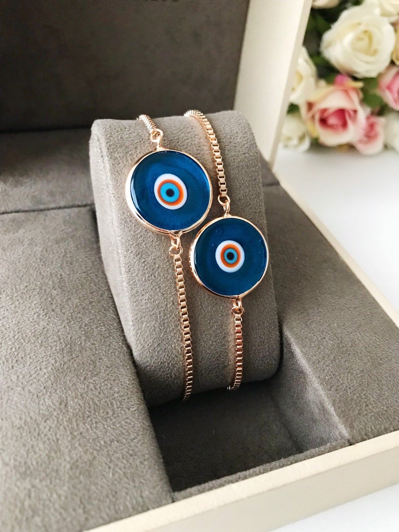 Murano Evil Eye Bracelet featuring a turquoise charm on an adjustable rose gold chain, showcasing intricate handmade details.